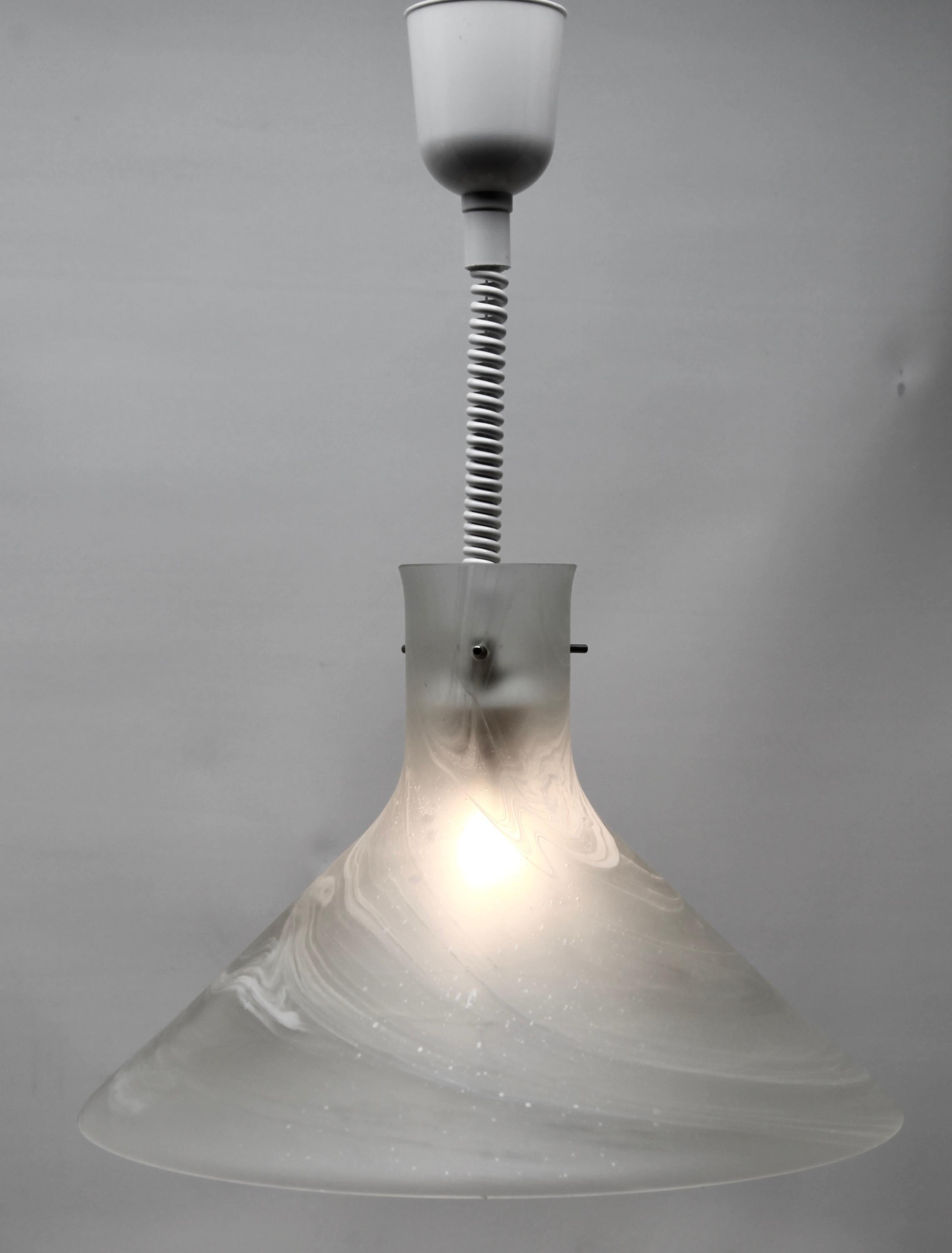 Vintage pendant light by Peill & Putzler, Germany. This central pendant light is crafted from heavy hand blown glass with dramatic swirling clouds of grey and white creating a brutalist feel, and has the trademark P&P peg mounting to secure the
