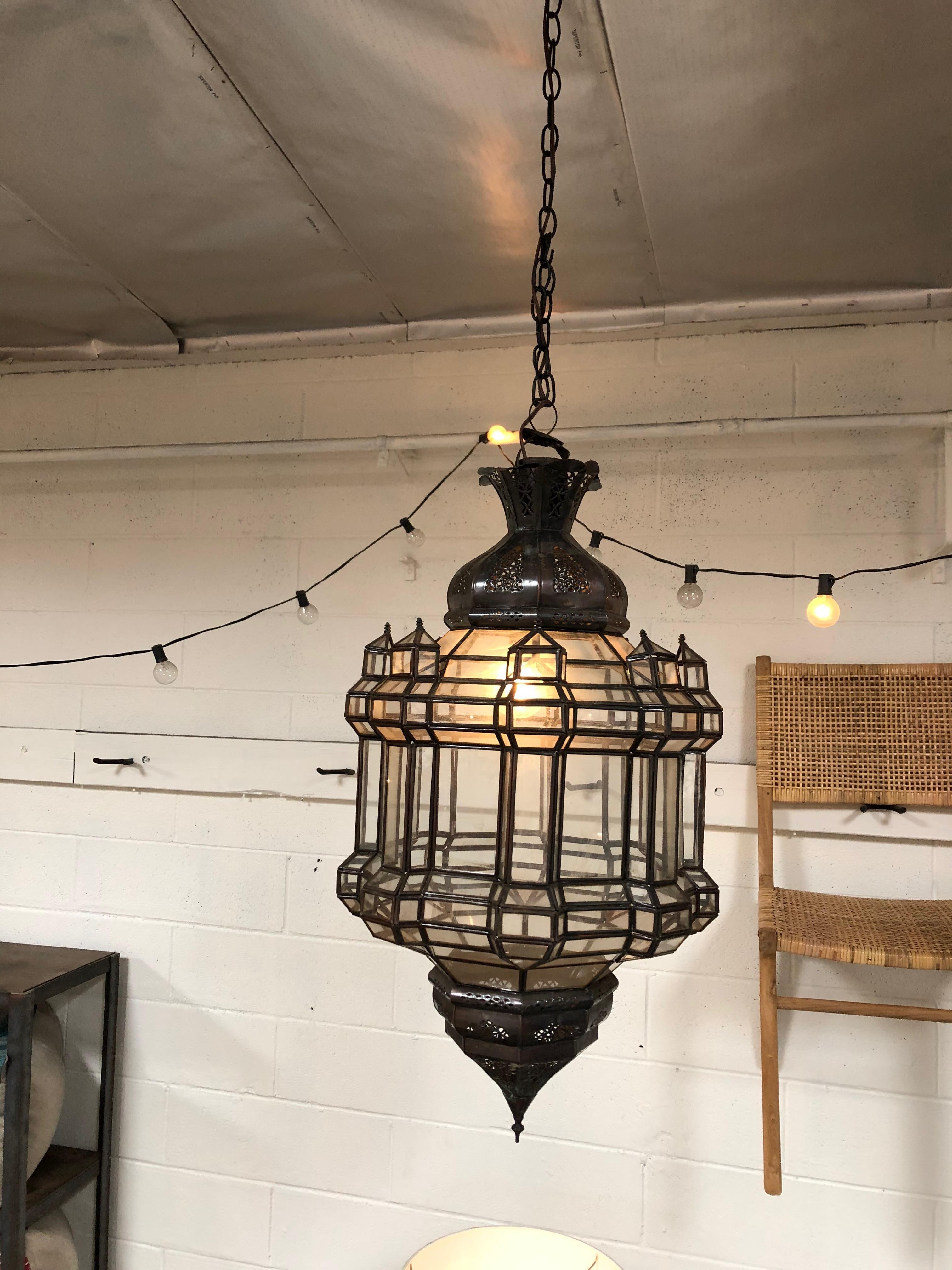 Mid-century vintage pendant light featuring a geometric frame design and perforated detailing.