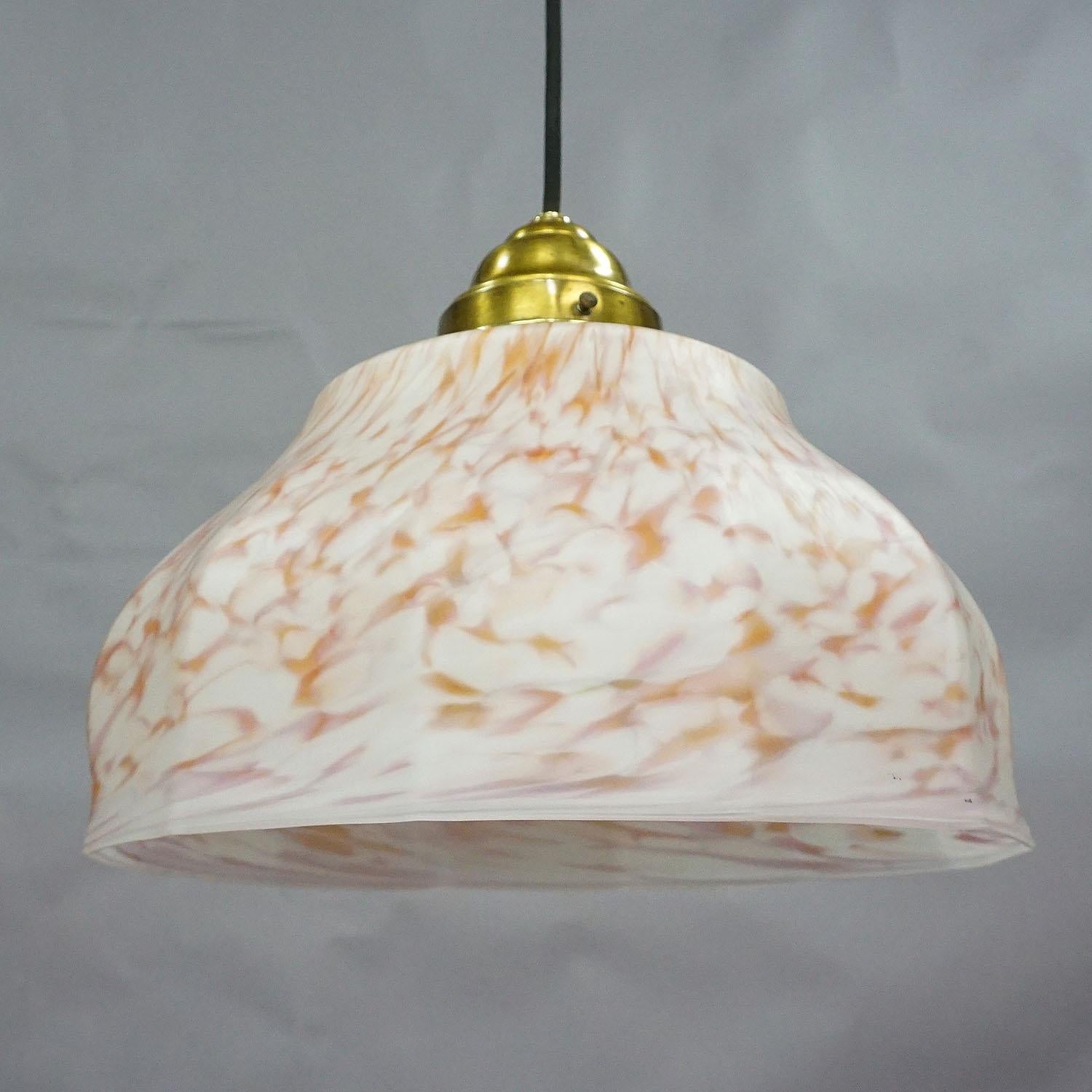 A vintage pendant lamp with a white and antique pink opaline glass shade and brass suspension. The cabling is renewed, working order, with international E27 base lamp holder.

Measures: Height 37.8