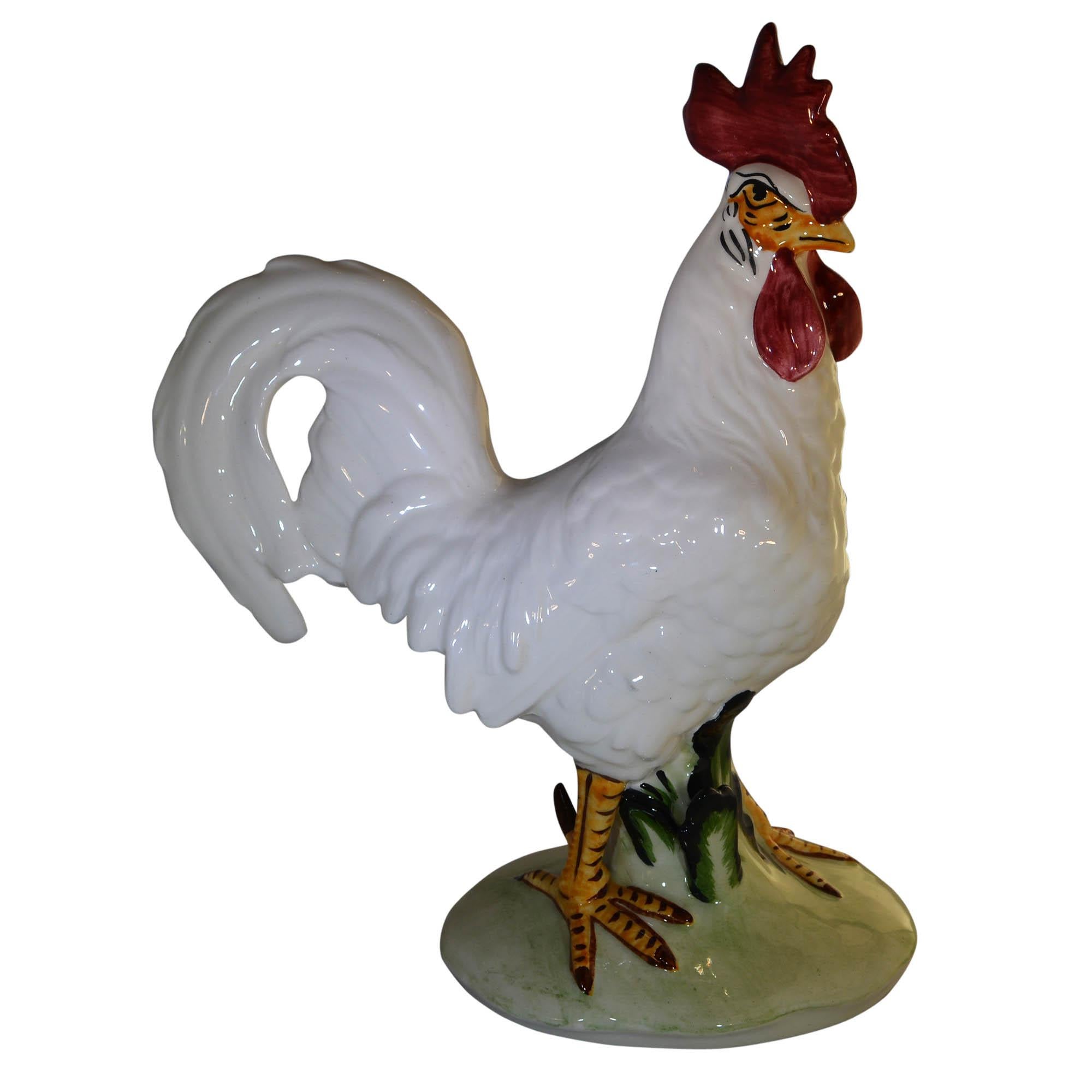 This impressive rooster from Pennsbury Pottery stands tall, giving all other a steely glare. His feet have detailed markings. He is standing in pale green grass.

Pennsbury Pottery was founded by Henry and Lee Below in Morrisville, Pennsylvania,