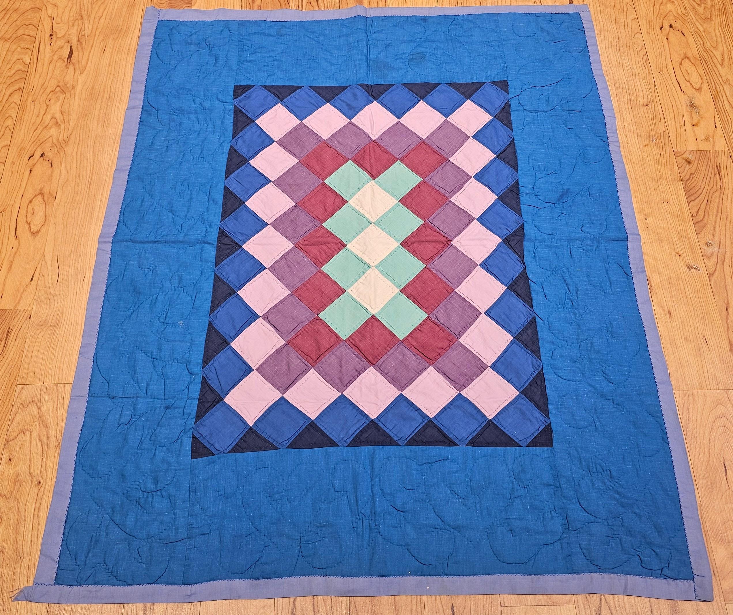 This beautifully hand-crafted Amish quilt, made in Lancaster County, Pennsylvania during the mid-1900s, features the beloved “Sunshine and Shadows” pattern—an enduring symbol of balance and tradition in Amish quiltmaking. Composed of hand-cut and