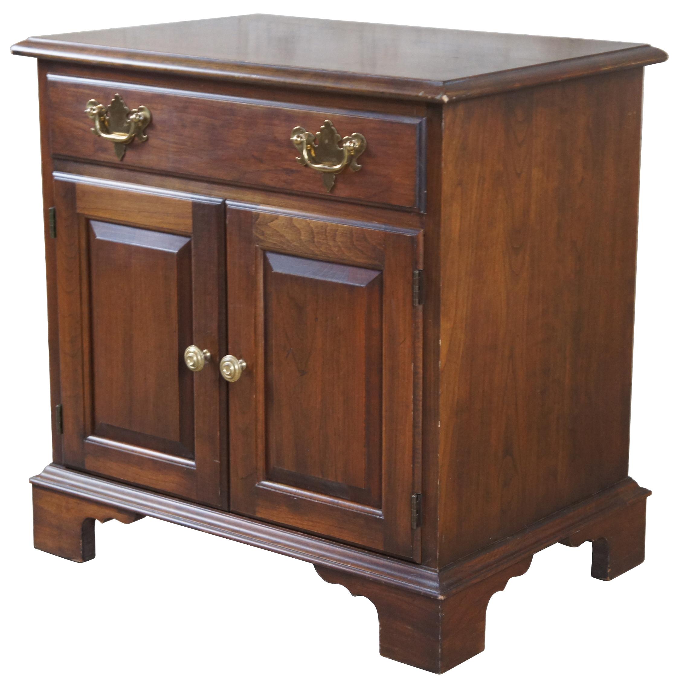 Vintage Pennsylvania House nightstand or cabinet. Made of cherry featuring one upper drawer and a cabinet with two doors and brass federal style hardware. Measures: 23”.
   