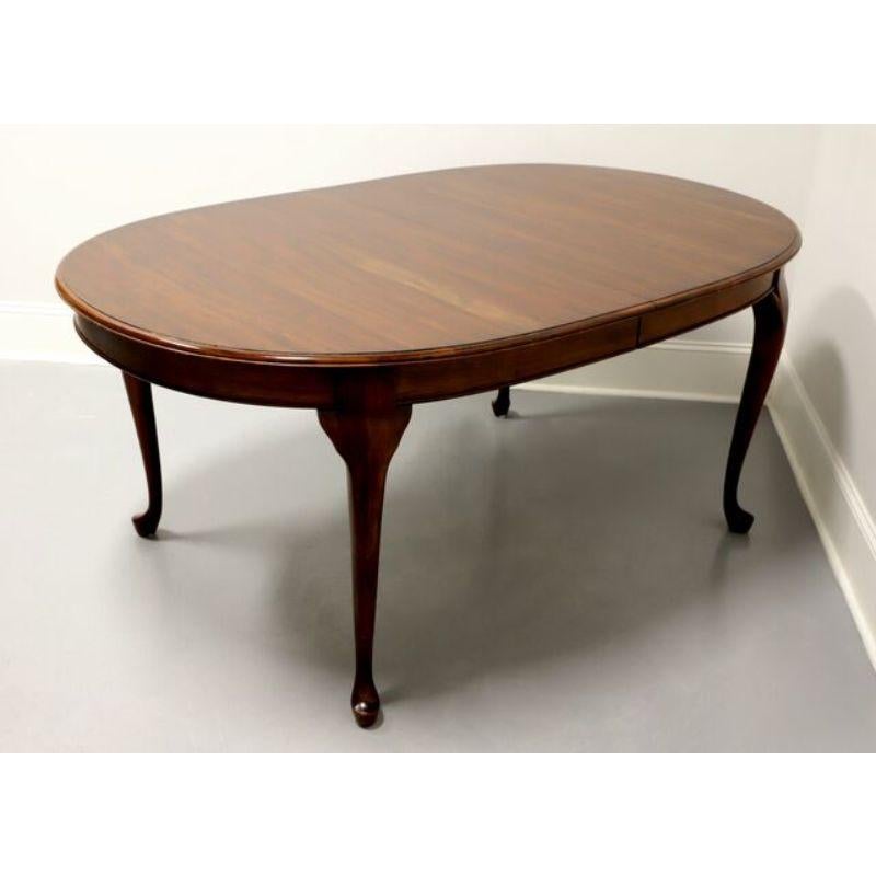 A Queen Anne style oval dining table by Pennsylvania House. Made of solid cherry, featuring a rounded edge, apron, cabriole legs and pad feet. Includes two extension leaves. Made in the USA, circa 1980's.

Measures: Overall: 66 W 44 D 29.25 H, Each