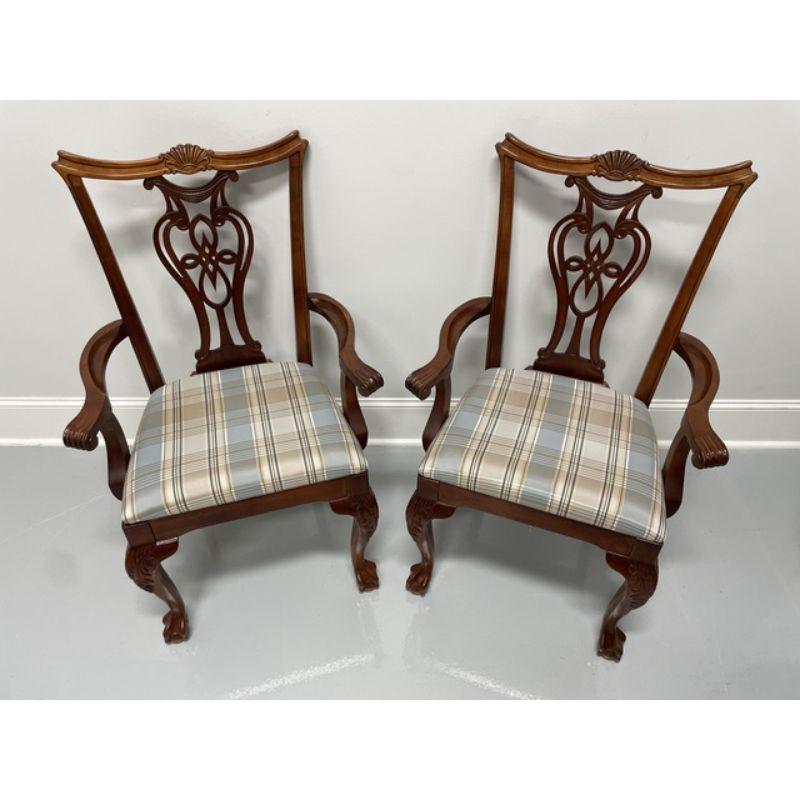 A pair of Chippendale style dining armchairs by Pennsylvania House. Solid Cherry with carved crest rails, carved backs, curved arms, light blue plaid fabric upholstered seats, carved acanthus leaf to knees, curved legs and ball in claw feet. Made in