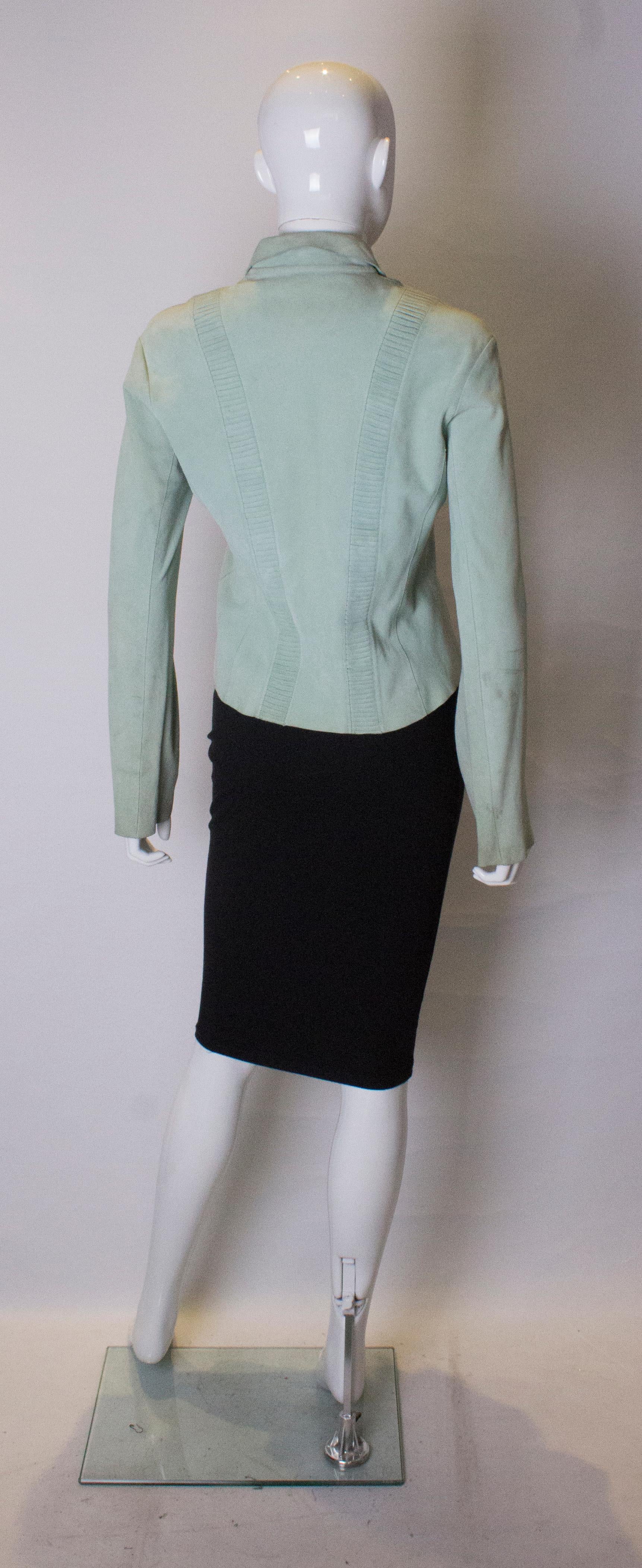 A chic peppermint green shirt in super soft suede. The shirt has pleat detail on the front and back, and a four button opening at the front.