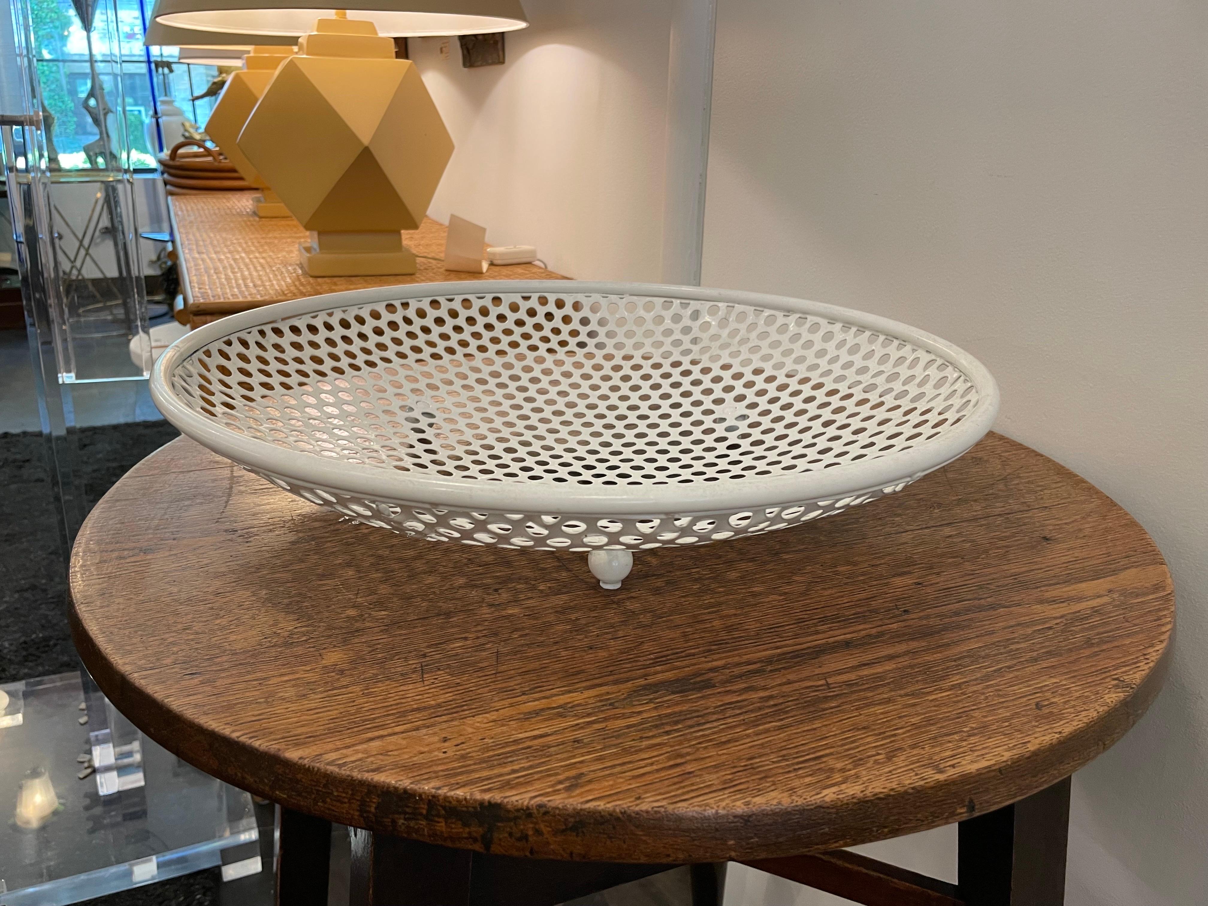 Round, footed table bowl in white perforated metal - in the style of Matthieu Mategot.