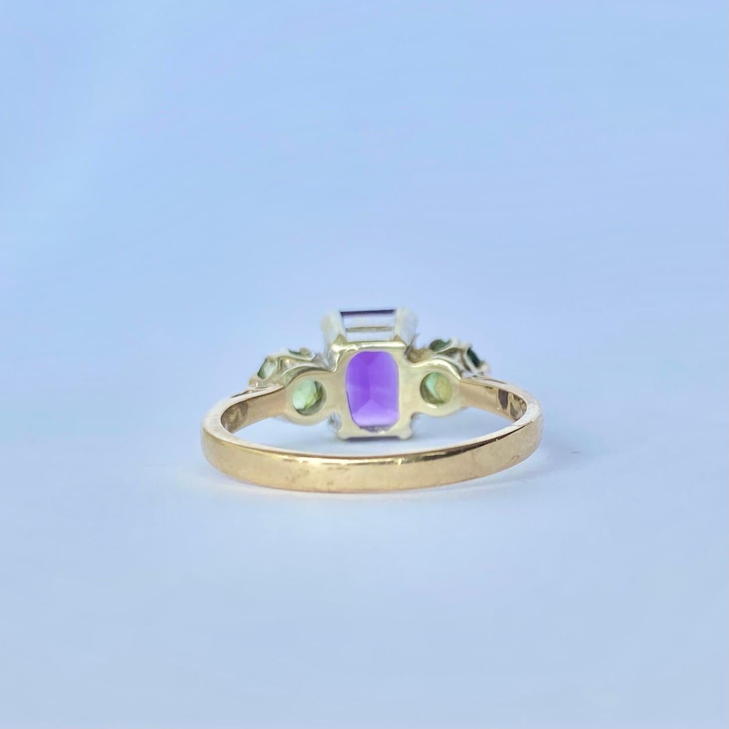 At the centre of this three stone is an emerald cut amethyst and either side are round peridot. The colours are beautiful together. The amethyst measures 1.10ct and the peridot total 70pts. Fully hallmarked Birmingham 1985.

Ring Size: M 1/2 or 6