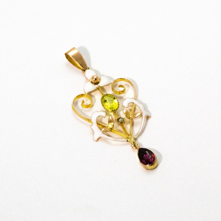 Delicate 9ct gold, glossy white enamel, sparkling Peridot and shimmering amethyst are the highlights of this beautiful suffragette pendant.

Pendant top to bottom: 1 3/4inches
