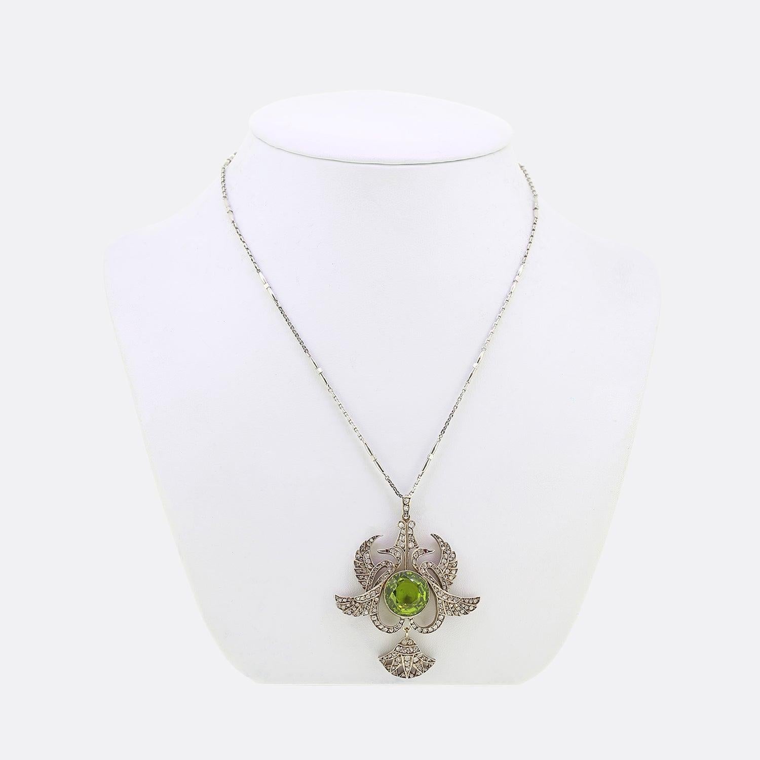 Here we have an excellently assembled vintage peridot and diamond necklace. The focal point of this piece is the large peridot which is milgrain set at the centre. This principle stone sits slightly risen amidst a frame crafted from silver into the