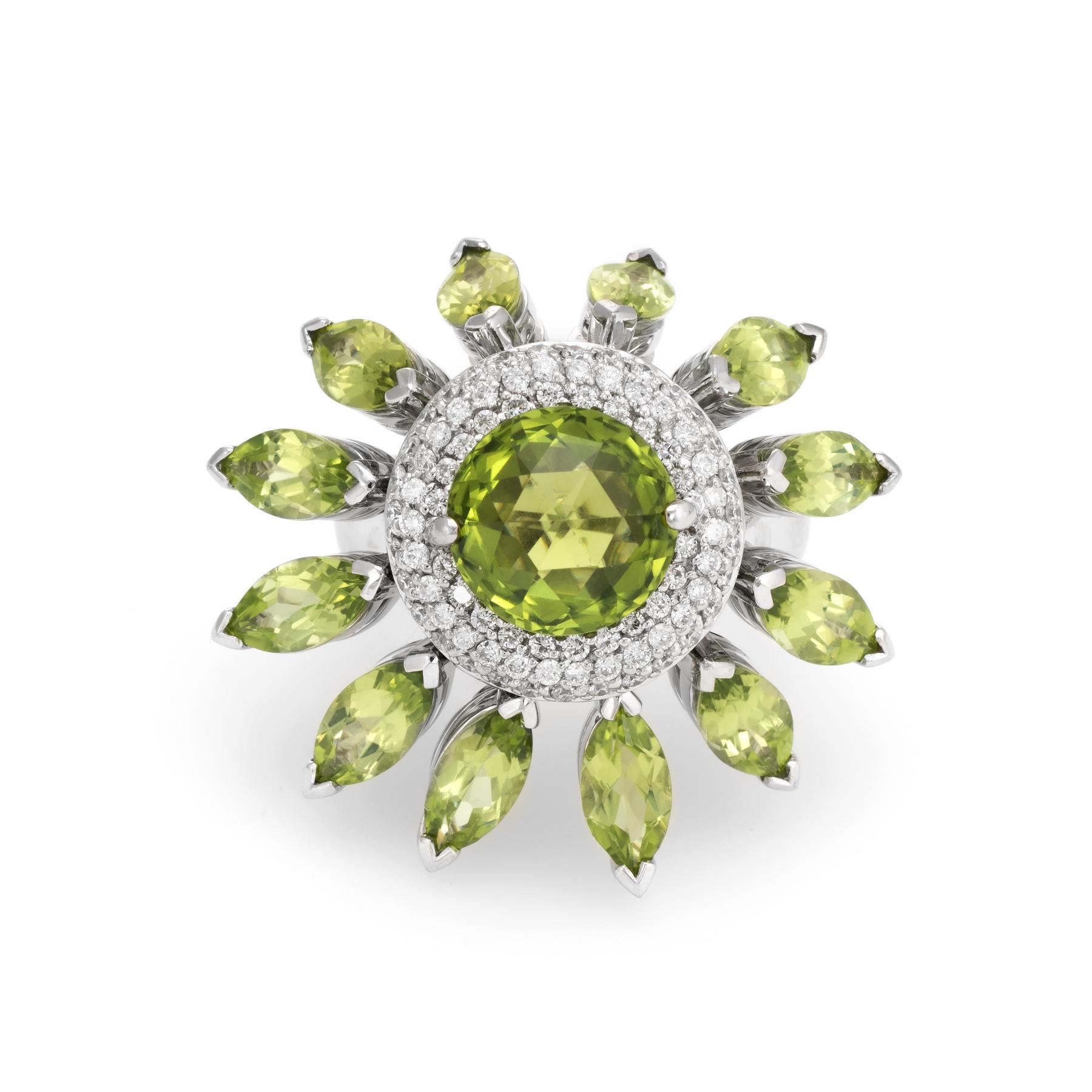 Finely detailed vintage cocktail ring, crafted in 18 karat white gold. 

Centrally mounted checkerboard faceted peridot measures 10mm (estimated at 4.50 carats). The accenting marquise cut peridot each measures 8mm x 4mm (estimated at 0.50 carats