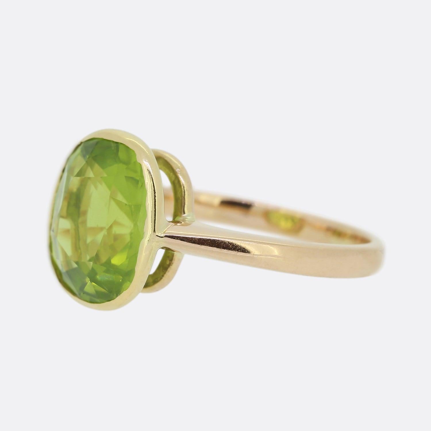 Here we have an 18ct rose gold peridot solitaire. The centralised peridot is a large oval shaped stone possessing an intense lime green hue which sits openly in a rub-over setting allowing the entire depth of the stone to be admired. 

Condition: