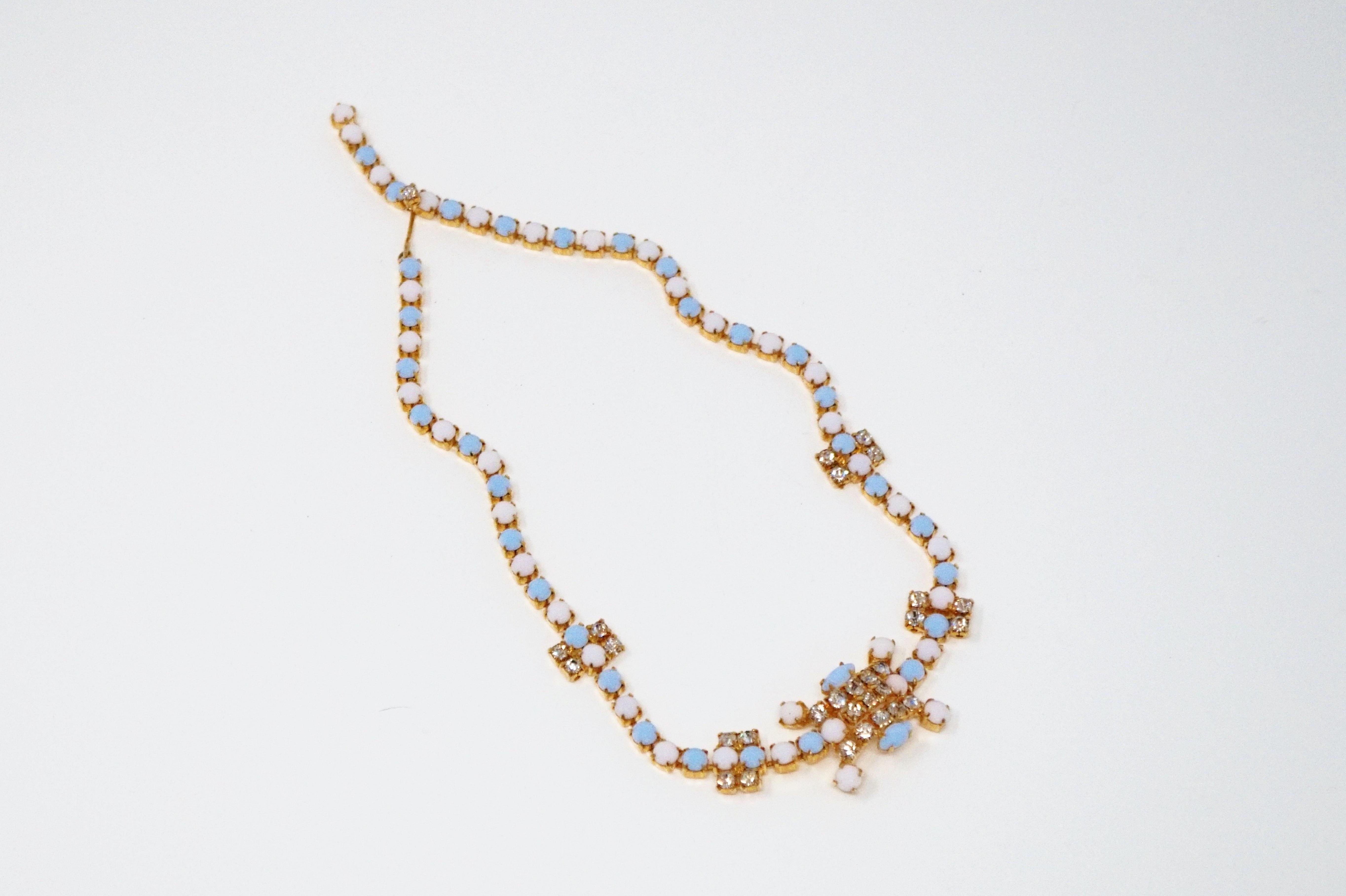 This beautiful vintage 1960s gold-plated periwinkle and white milk glass necklace with rhinestone accents is a must-have for vintage jewelry lovers! Feminine and glamorous, this piece makes a wonderful addition to your vintage jewelry