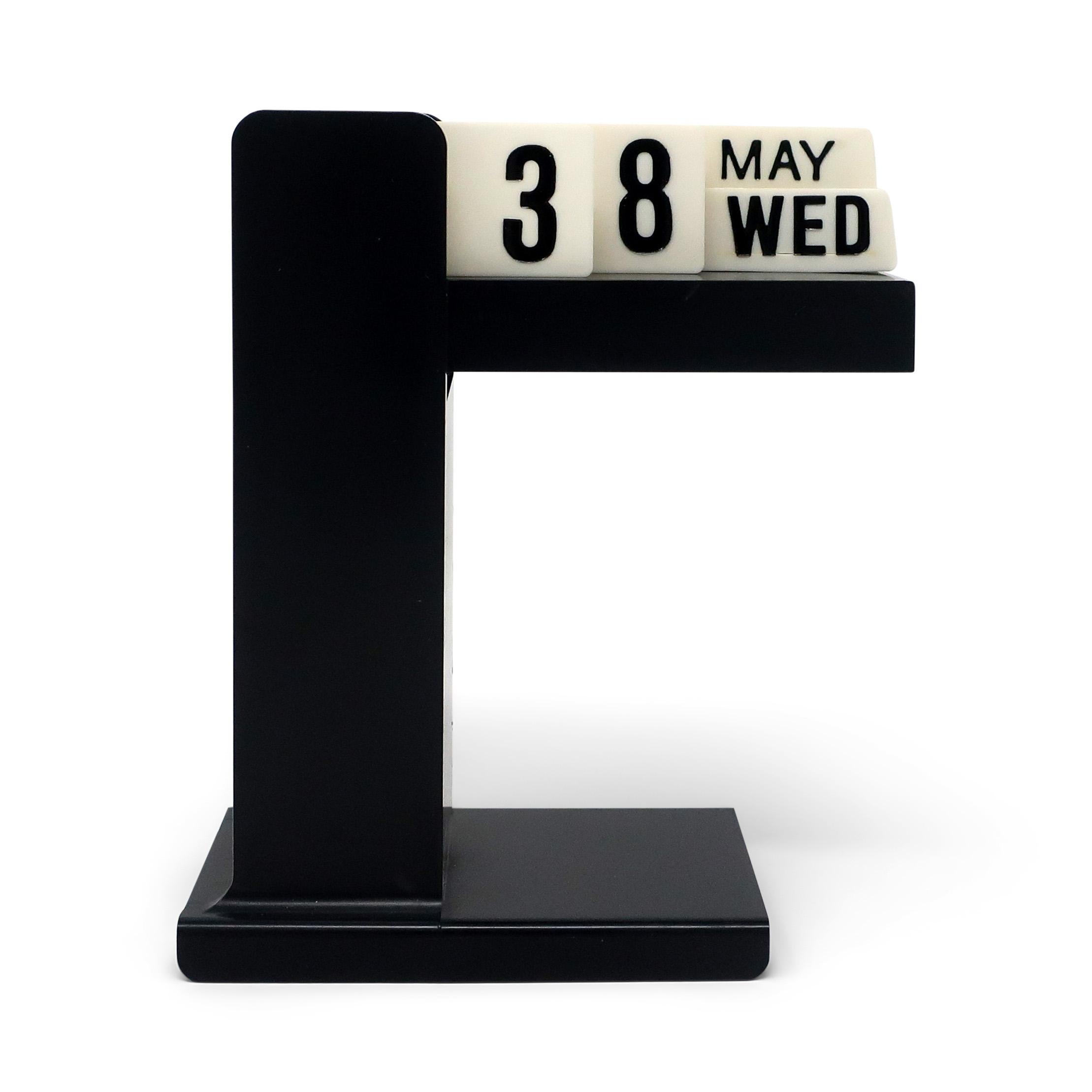 In the style of Enzo Mari’s Timor calendar for Danese Milano from 1967, this perpetual flip desk calendar has a black base and white strips that can be rotated to track the month, date, and day of the week. In excellent vintage condition with wear