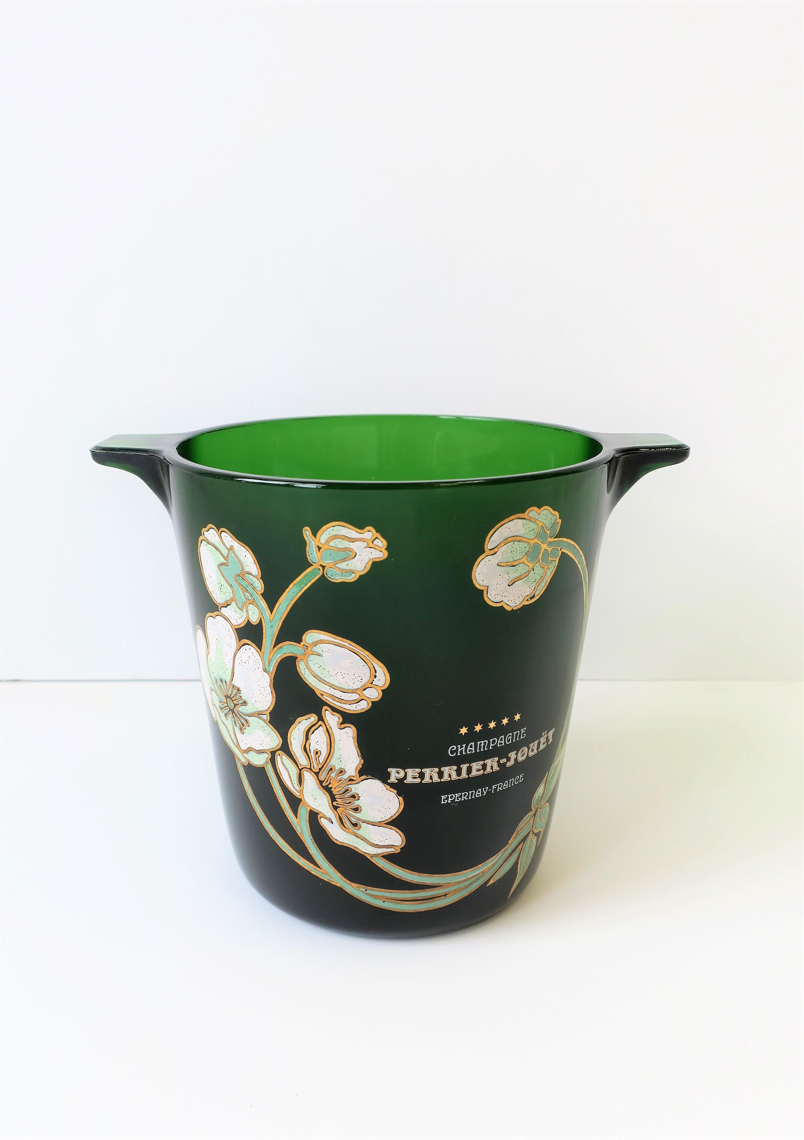 A very beautiful vintage Perrier-Jouet French Champagne bucket with iconic floral motif in the Art Nouveau style. Piece is substantial emerald green glass with raised relief on front. Bucket can be used as an 'ice bucket' or as a Champagne/wine