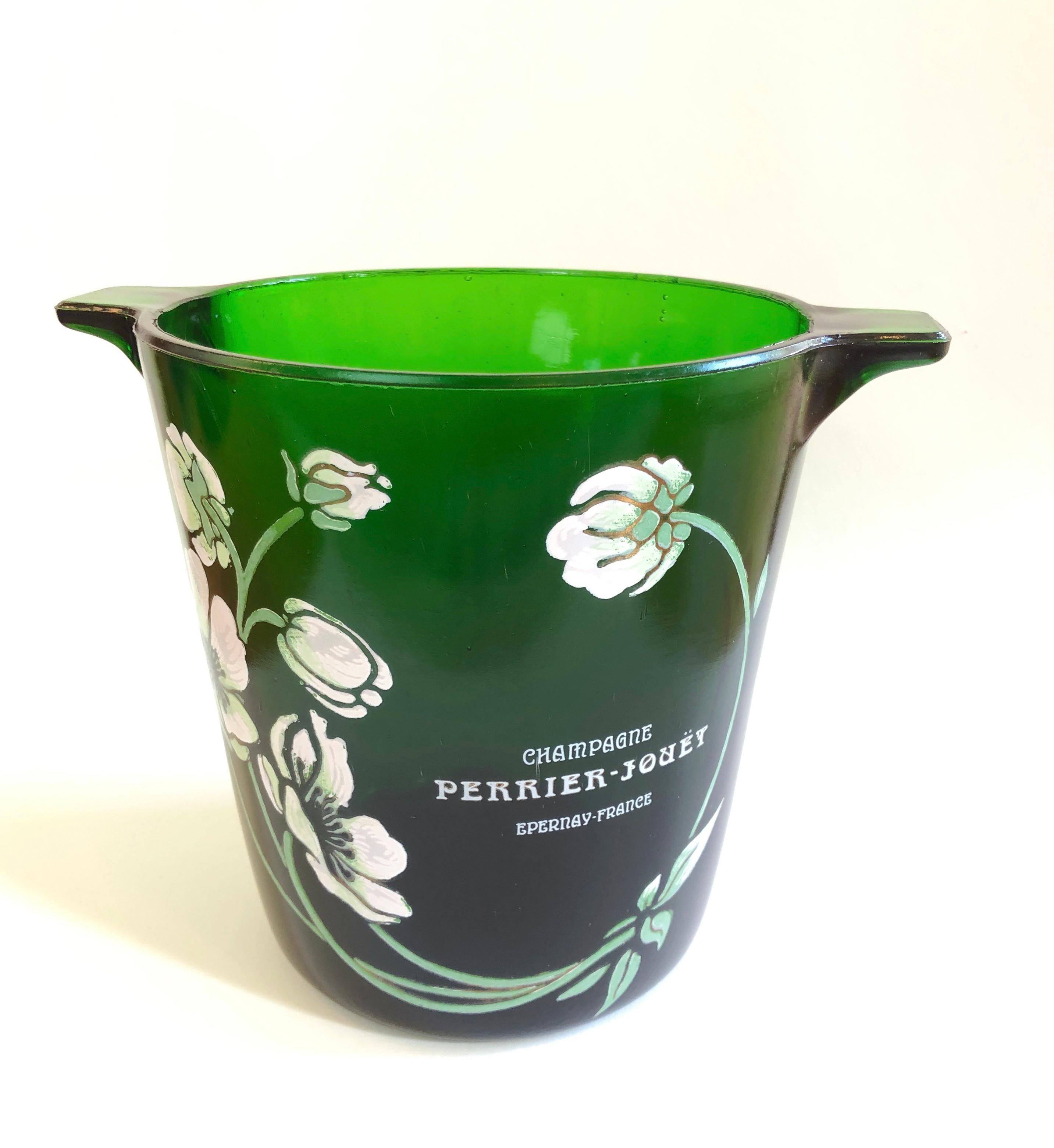 A very beautiful vintage Perrier-Jouet French Champagne bucket with iconic floral motif in the Art Nouveau style. Piece is substantial emerald green glass with raised enamel relief in mint & mild white to pink floral design.

A state-of-the-art