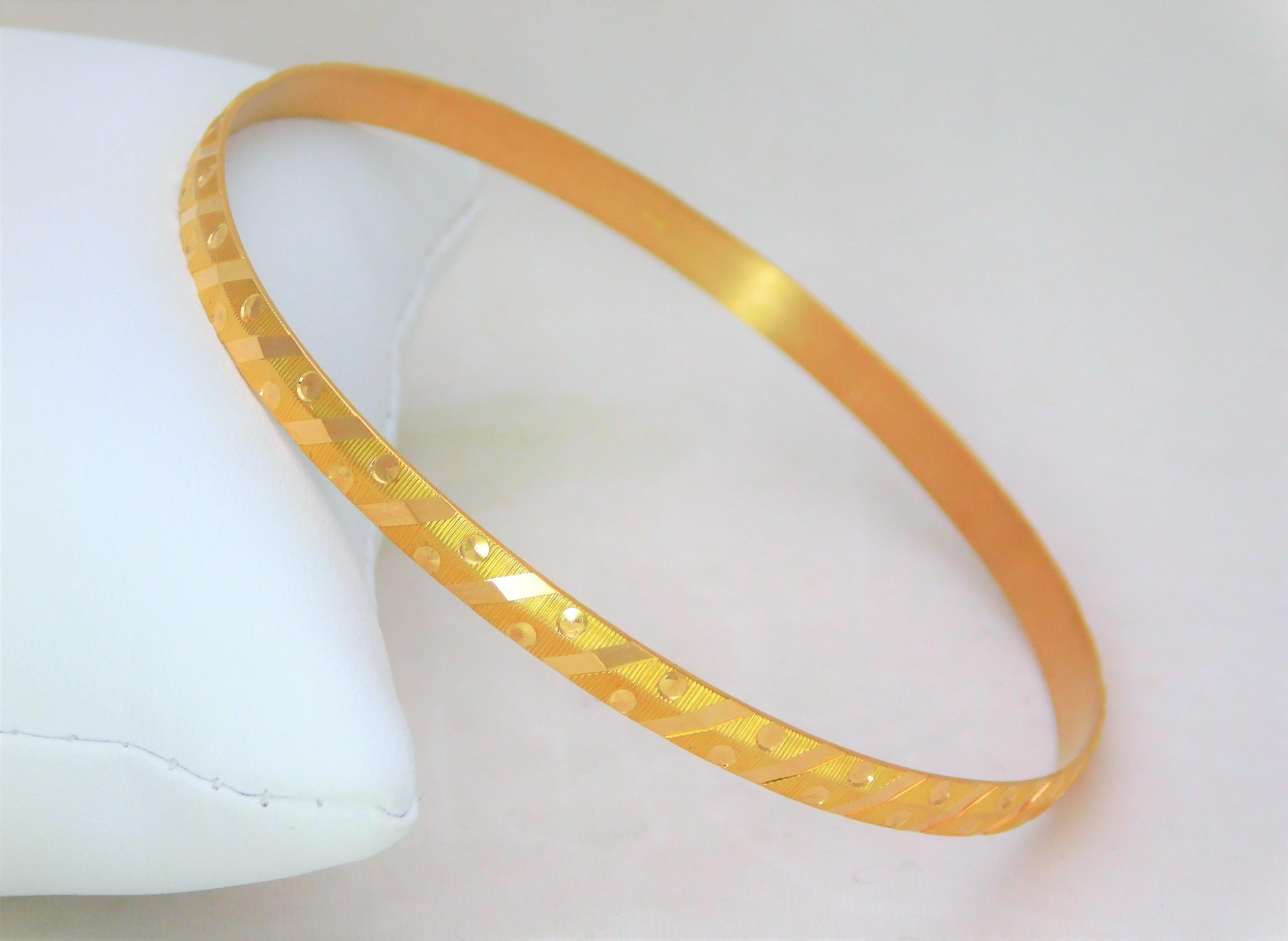 Purchased in the Middle-East. Circa 1970. This stunning bangle style bracelet has been crafted in 21k yellow gold. It is in amazing original condition. Our restoration only included light hand polishing. This miraculous piece features ornate