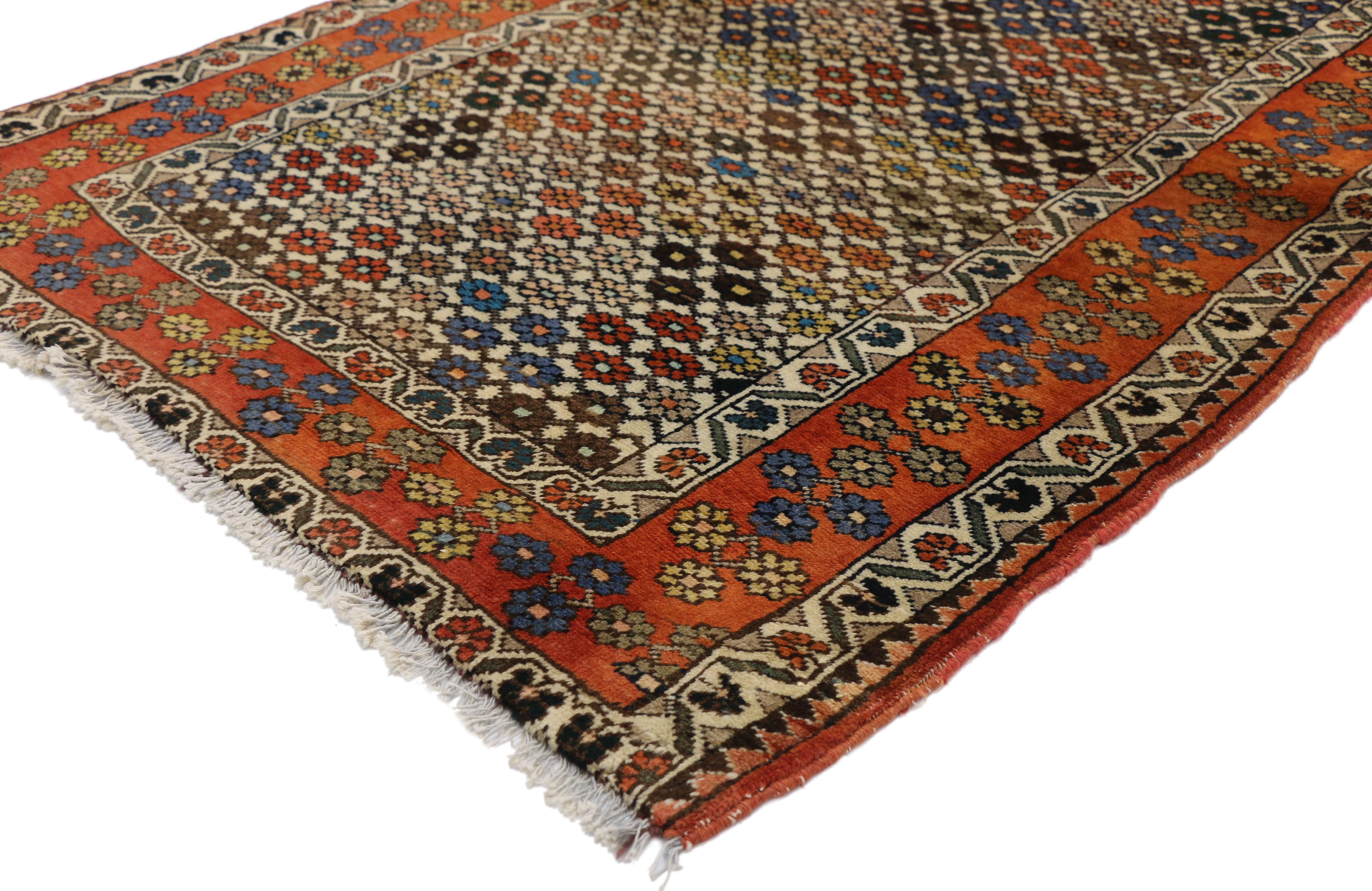 75750, vintage Persian Afshar accent rug in Nomadic Village style. This hand knotted wool vintage Persian Afshar rug features an all-over floral pattern creating an eye-catching lattice design. Quadrants of stylized flower roundels in are laid in