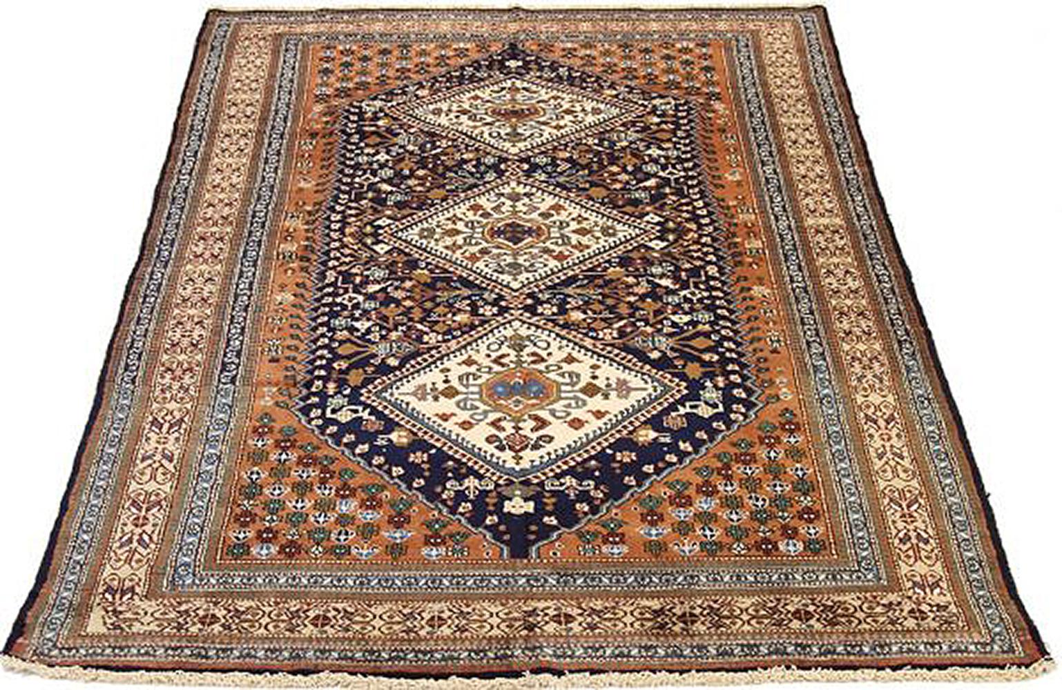 Vintage Persian rug handwoven from the finest sheep’s wool and colored with all-natural vegetable dyes that are safe for humans and pets. It’s a traditional Ardebil design featuring ivory and brown diamond medallions on a navy and beige field. It’s