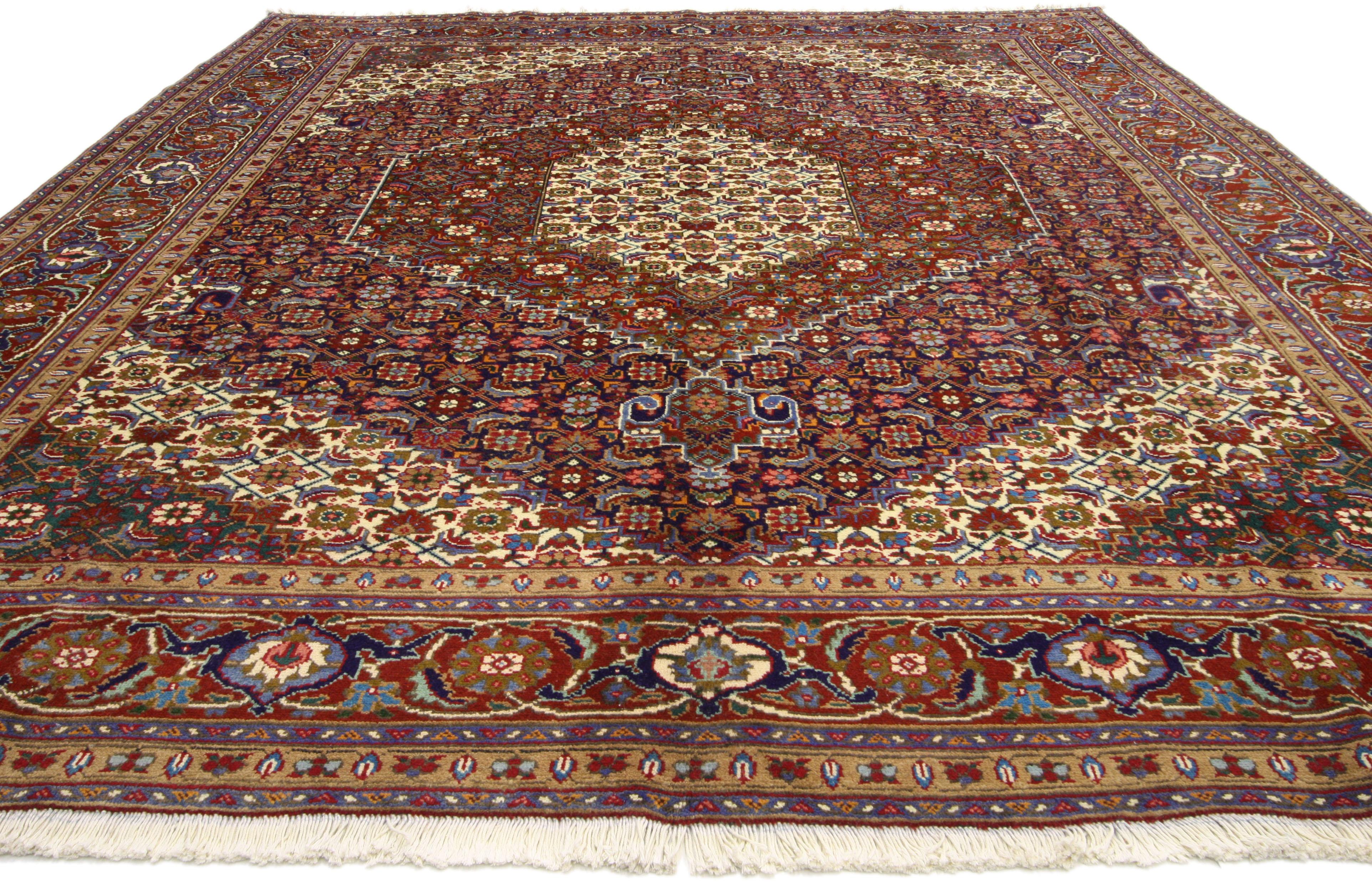 76150, vintage Persian Azerbaijan area rug with Mahi fish design Manor House style. This hand knotted wool vintage Persian Azerbaijan rug beautifully showcases a Mahi Fish Design in a rich jewel-tone color palette. A grandeur lozenge and two