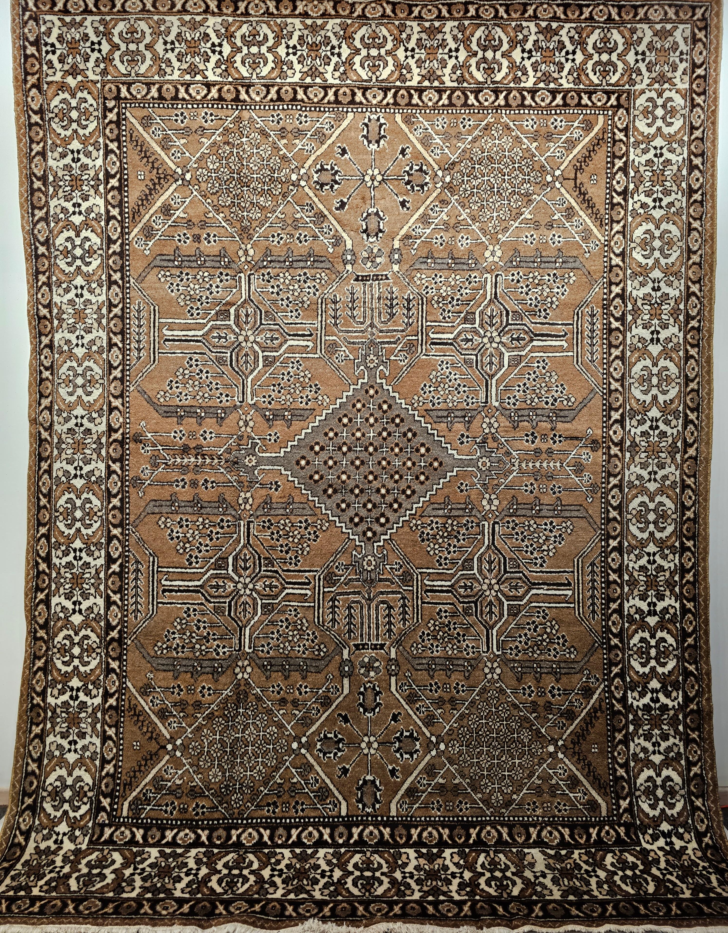 A beautiful vintage Persian Bakhtiari room size rug in an all over geometric pattern with natural wool colors including camelhair, ivory, dark gray, and black.  This Bakhtiari rug was hand woven by the Bakhtiari tribes in the western Persia in the