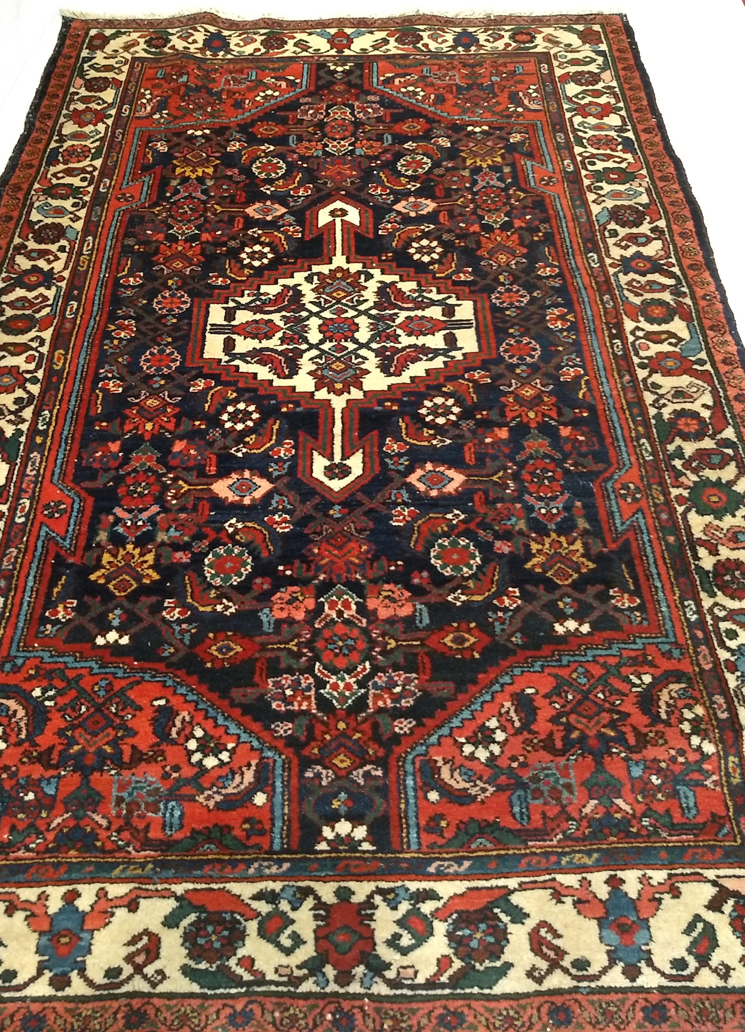 Vintage Persian Bakhtiari tribal rug from Western Persia from the 1st half of the 1900s in a medallion pattern.  Bakhtiari rugs are renowned for their beautiful design and the use of brilliant colors produced by the use of natural organic dyes.  The