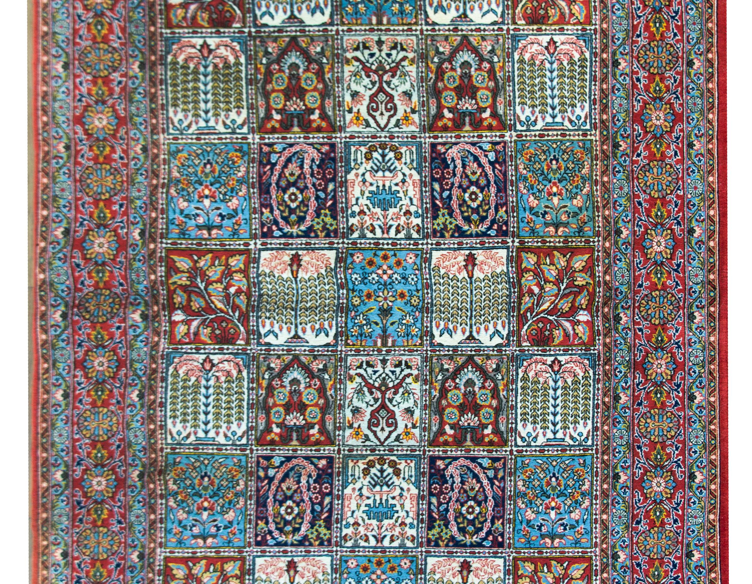 A wonderful vintage Persian Bakhtiari rug with an all-over patcherwork pattern with several repeated floral, paisley, weeping willow tree, and trees-of-life patterns, and surrounded by a border with a wide central floral stripe flanked by pairs of