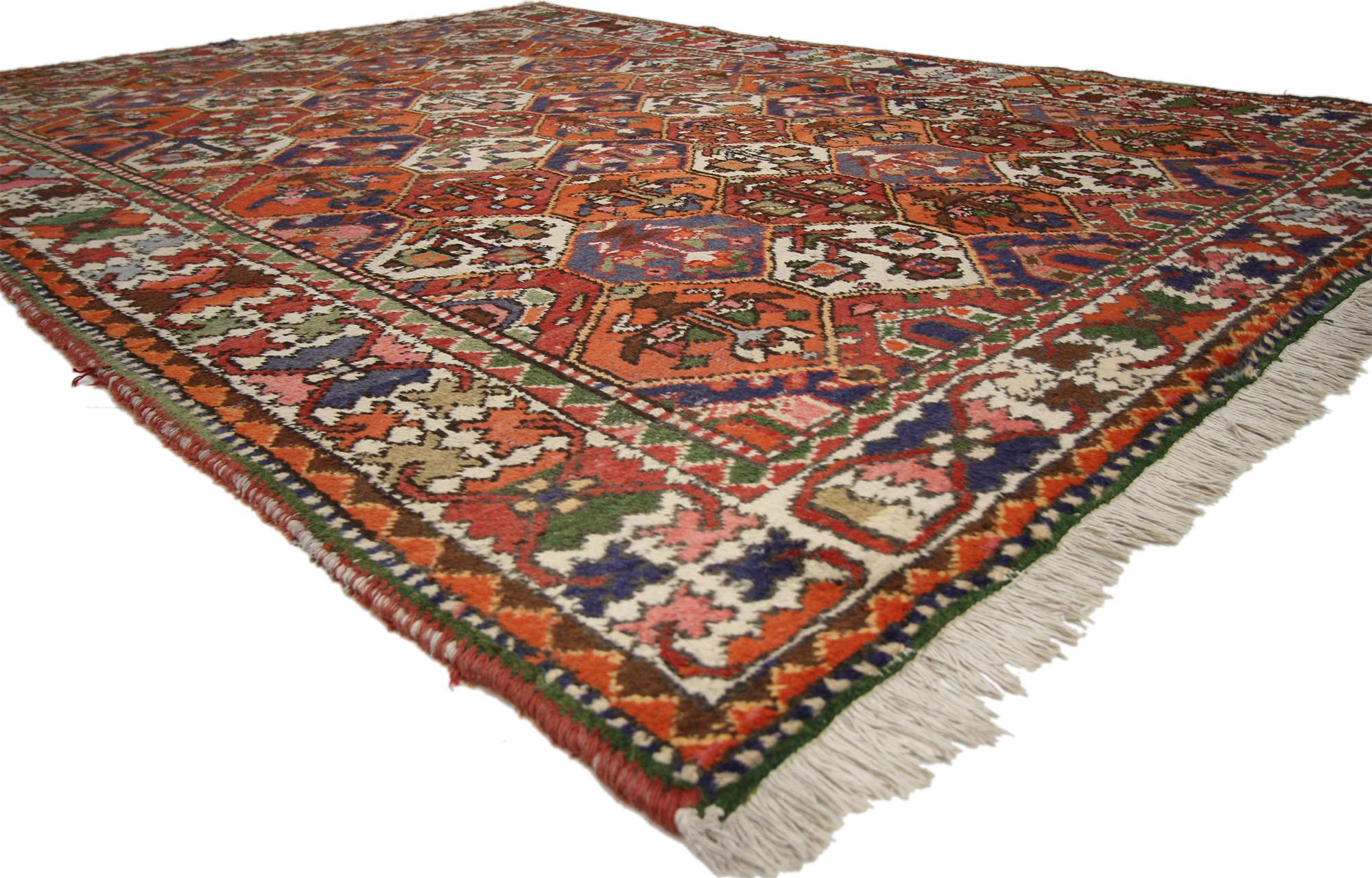 This hand-knotted wool vintage Persian Bakhtiari rug features a Four Seasons garden design in a traditional color palette. Stylishly composed with an intimate patina, this vintage Bakhtiari rug reflects the finer points of timeless Persian rug
