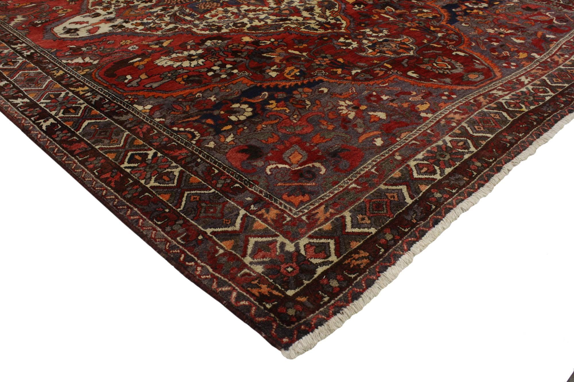 76892 Vintage Persian Bakhtiari Rug with Traditional Style. Rustic and refined with understated elegance, this hand-knotted vintage Persian Bakhtiari rug with traditional style features an octofoil medallion surrounded by lush palmettes, vines and
