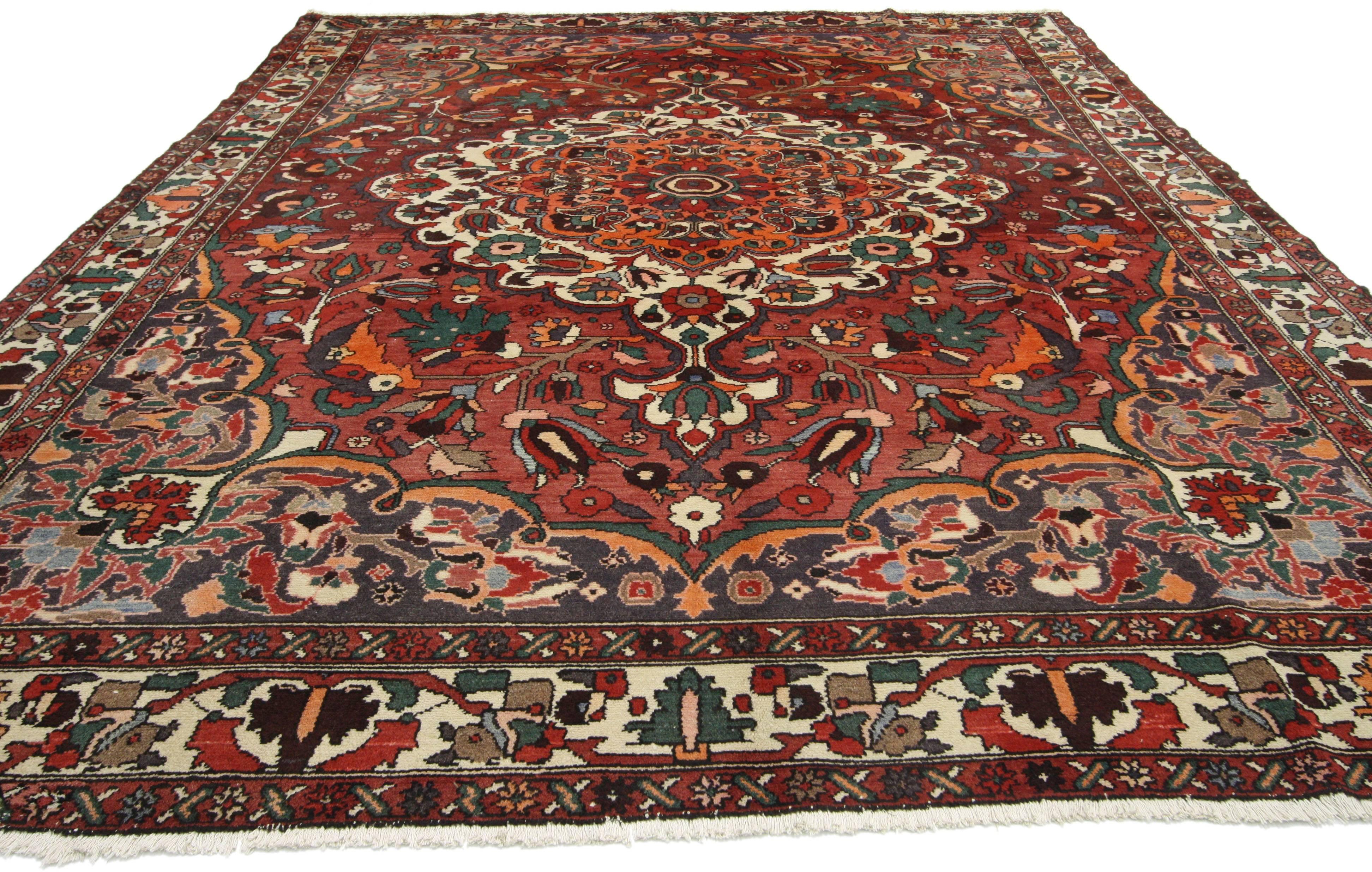 76142, vintage Persian Bakhtiari rug with traditional style. This hand-knotted vintage Persian Bakhtiari rug with traditional style features a central medallion filled with an array of lotus, Iris and Peony flowers surrounded by lush palmettes,