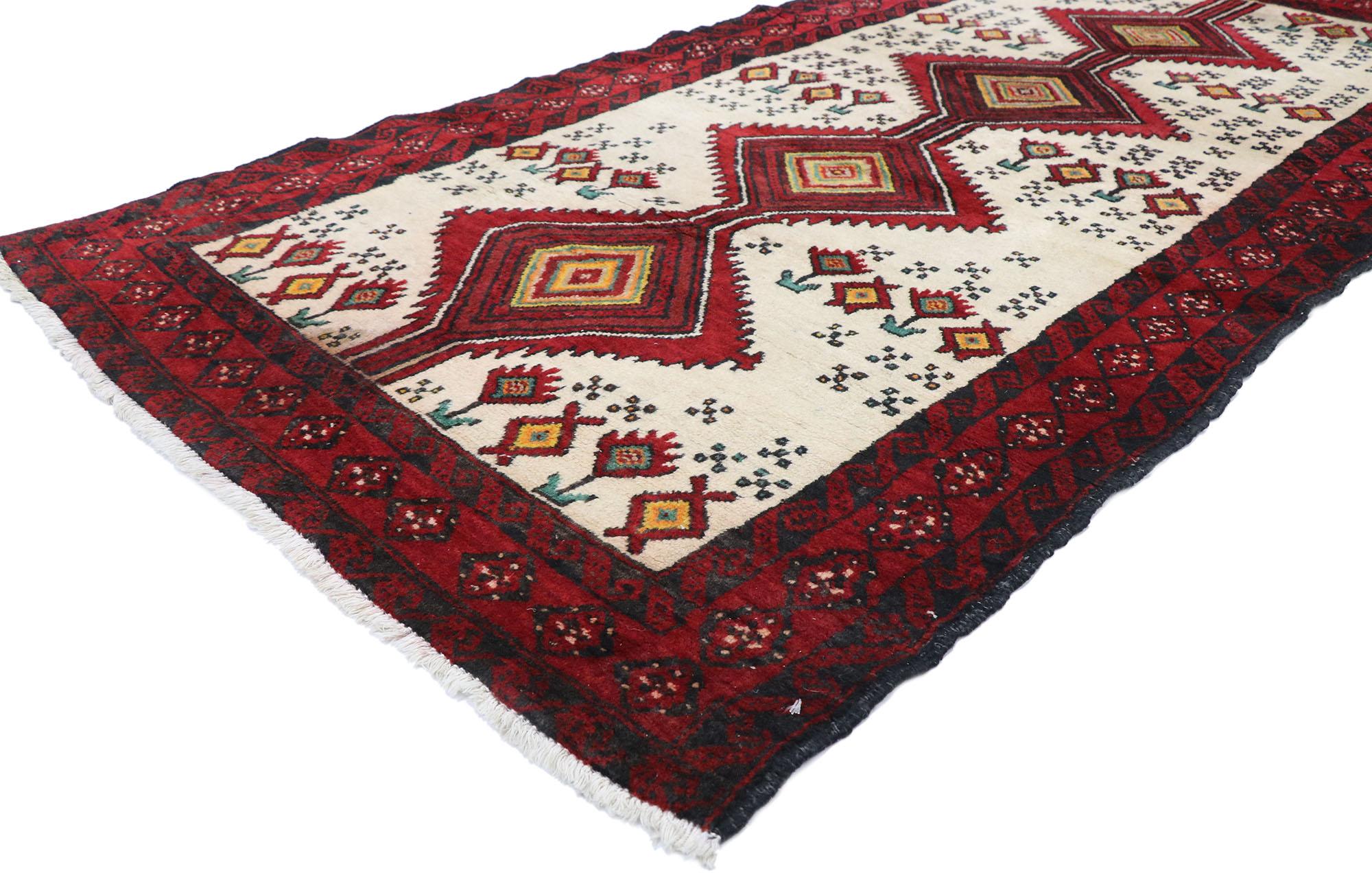 77712 Vintage Persian Baluch rug with Tribal Style 03'04 x 06'06. Warm and inviting with nomadic village charm, this hand-knotted wool vintage Persian Baluch rug is a captivating vision of woven beauty. A serrated pole medallion decorated with