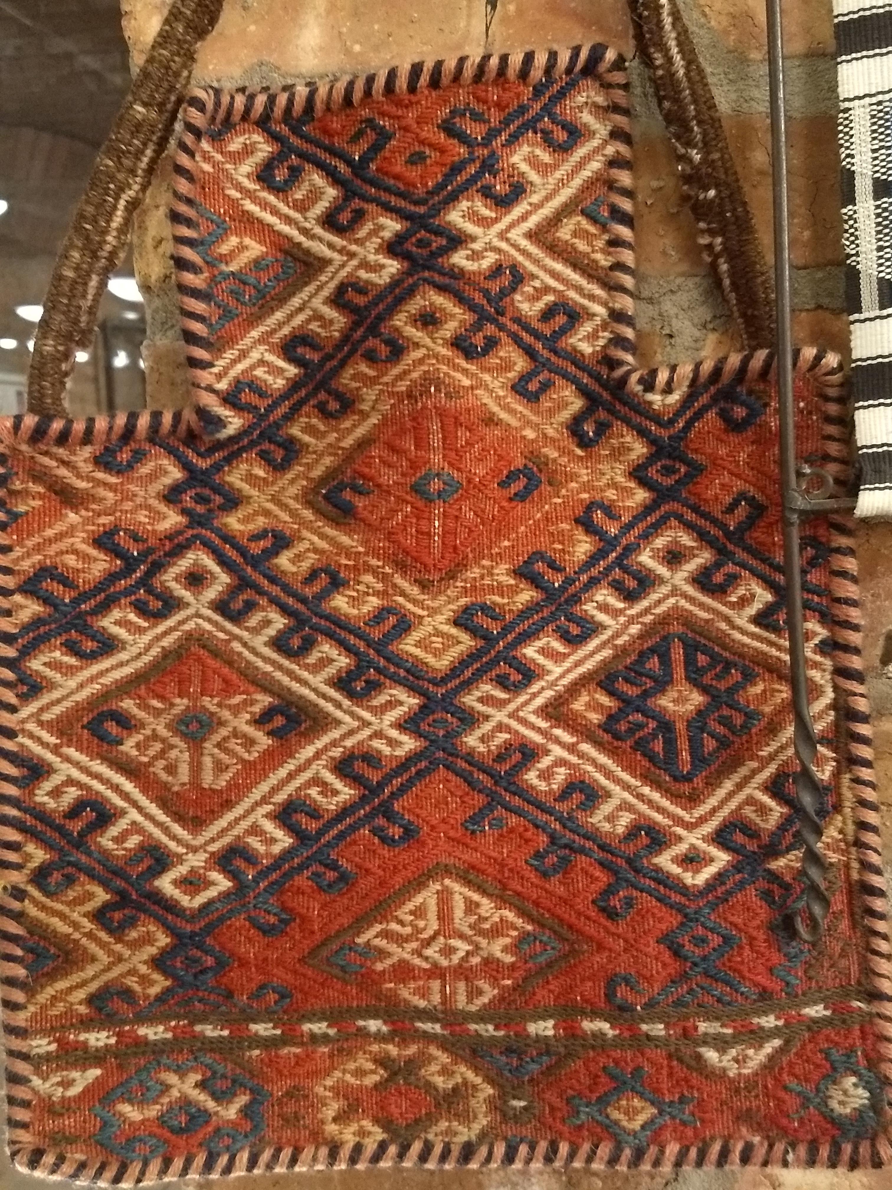A vintage Baluch tribal salt bag with geometric pattern in red, blue and brown colors.  A tribal salt bag for preserving and transporting salt during migration. 
For the tribal people salt has always been one of the most important and precious