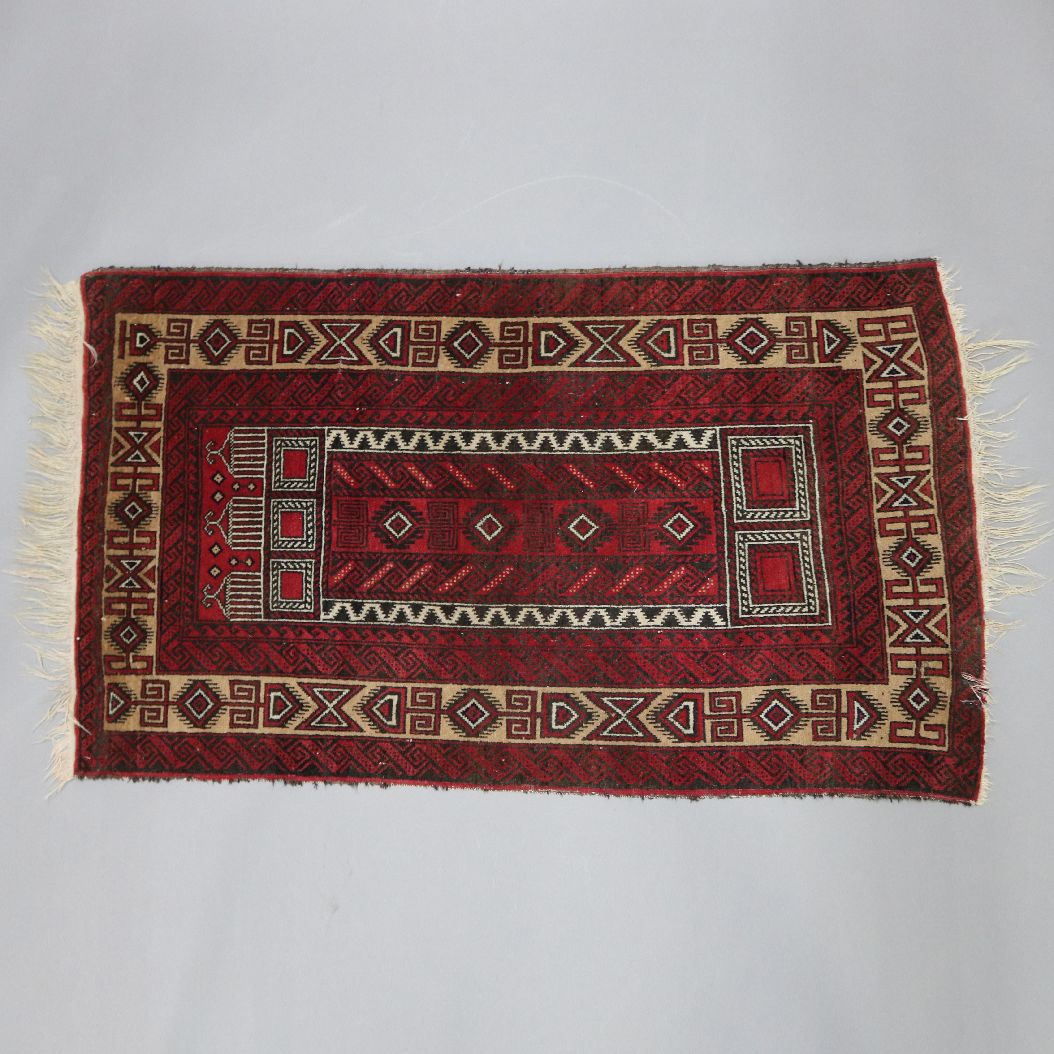 A vintage Persian Baluch tribal prayer rug offers stylized mosque and feather decoration on red ground, circa 1940.

Measures: 62