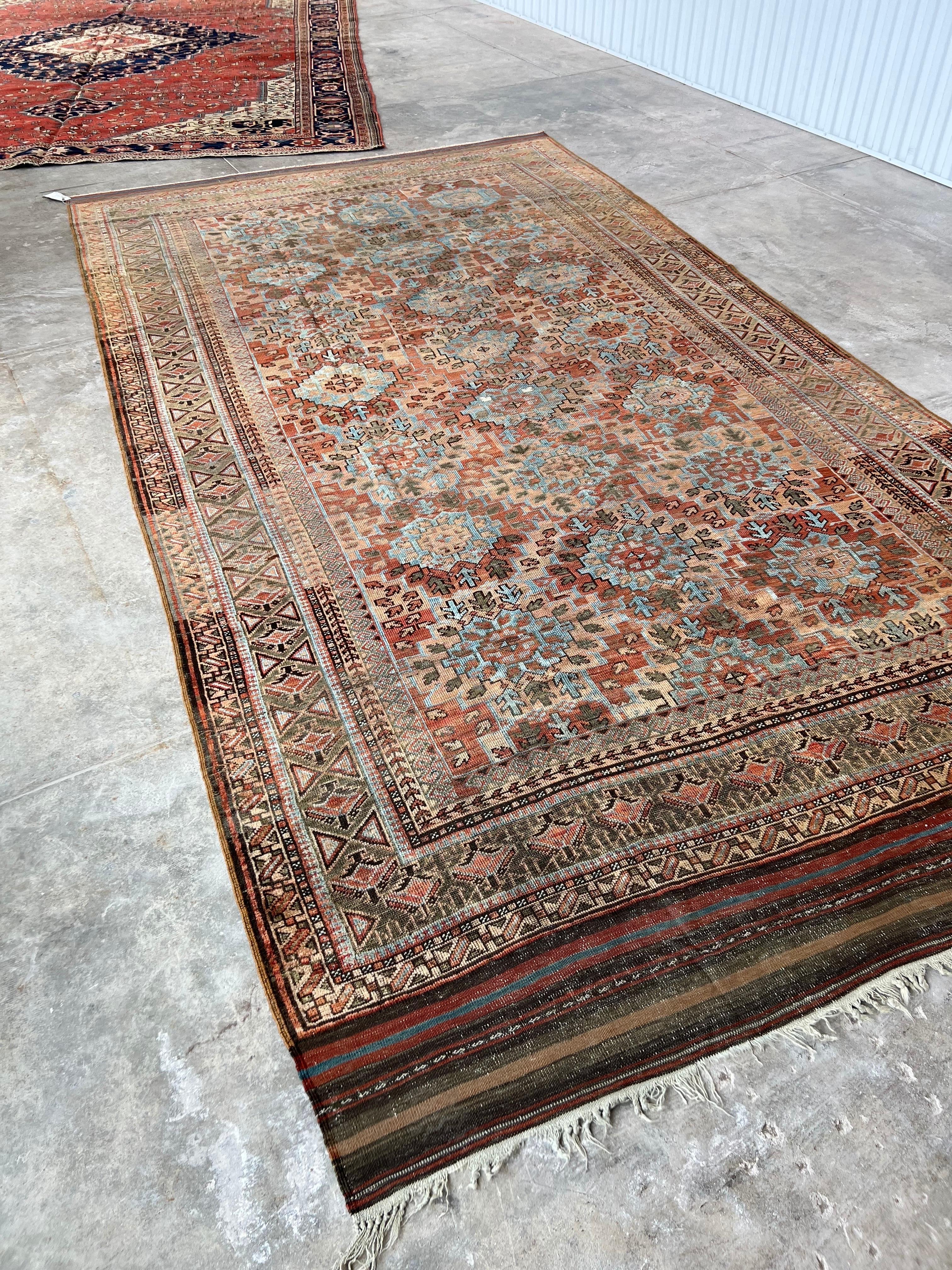 There are so many textures on this one rug! Baluch rugs were made by nomadic tribes. Each end is finished with a lovely flatweave and wild original fringe. This rug is soft and thin. Make sure to get a hefty felt and rubber rug pad to keep it in