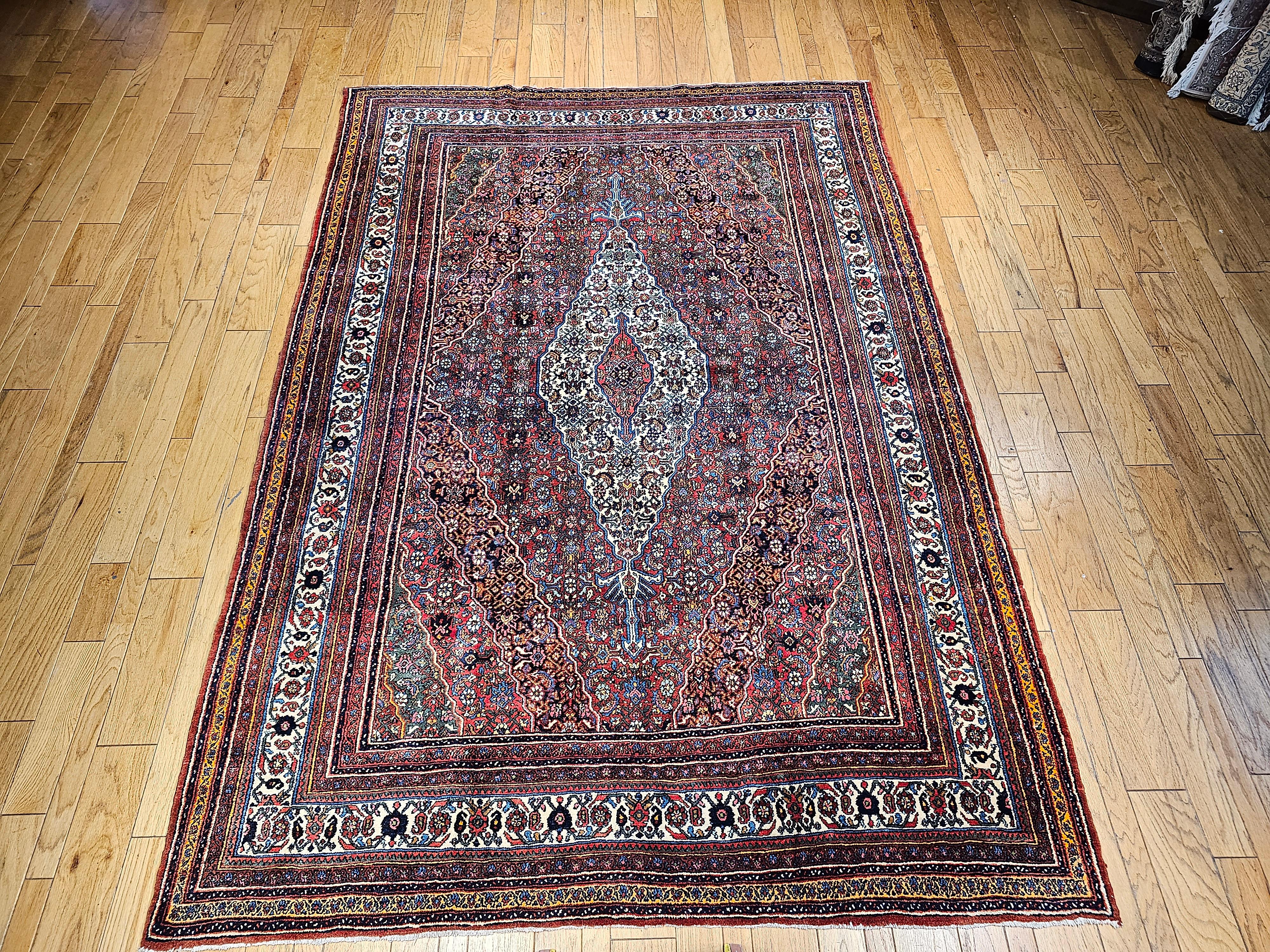 Vintage Persian Bibikabad in Herati pattern  in a rust red, French blue, and green colors from the early 1900s.  The Bibikabad rugs are recognized for their unique and beautiful elongated medallions which is part of their signature design.  The