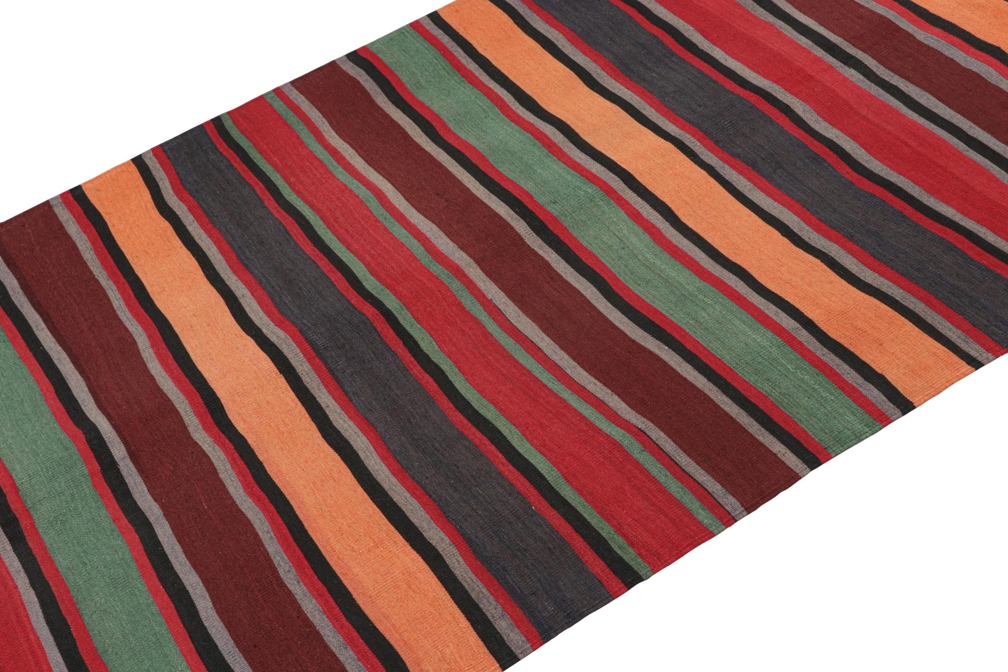 This vintage 5x13 Persian Bidjar Kilim is handwoven in wool, and originates circa 1950-1960.

On the Design:

This flatweave enjoys polychromatic stripes favoring orange, red, blue, brown & green colorways.
It’s a warm, vibrant choice with vast
