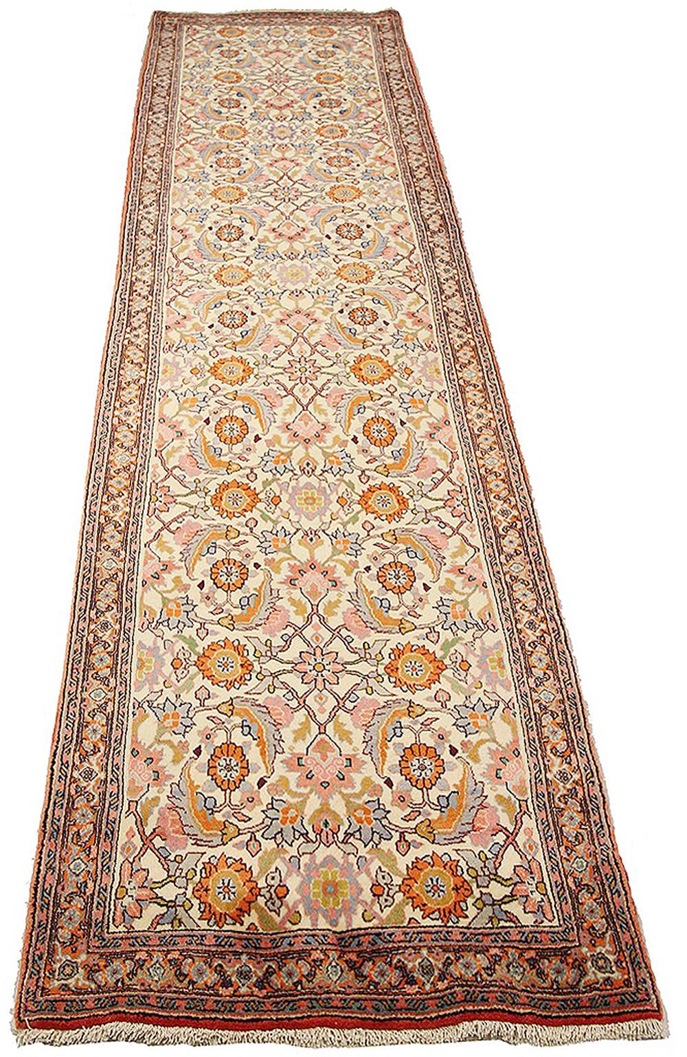 Vintage Persian runner rug handwoven from the finest sheep’s wool and colored with all-natural vegetable dyes that are safe for humans and pets. It’s a traditional Bijar design featuring lovely colors of pink, gray, and beige. It has all-over rows