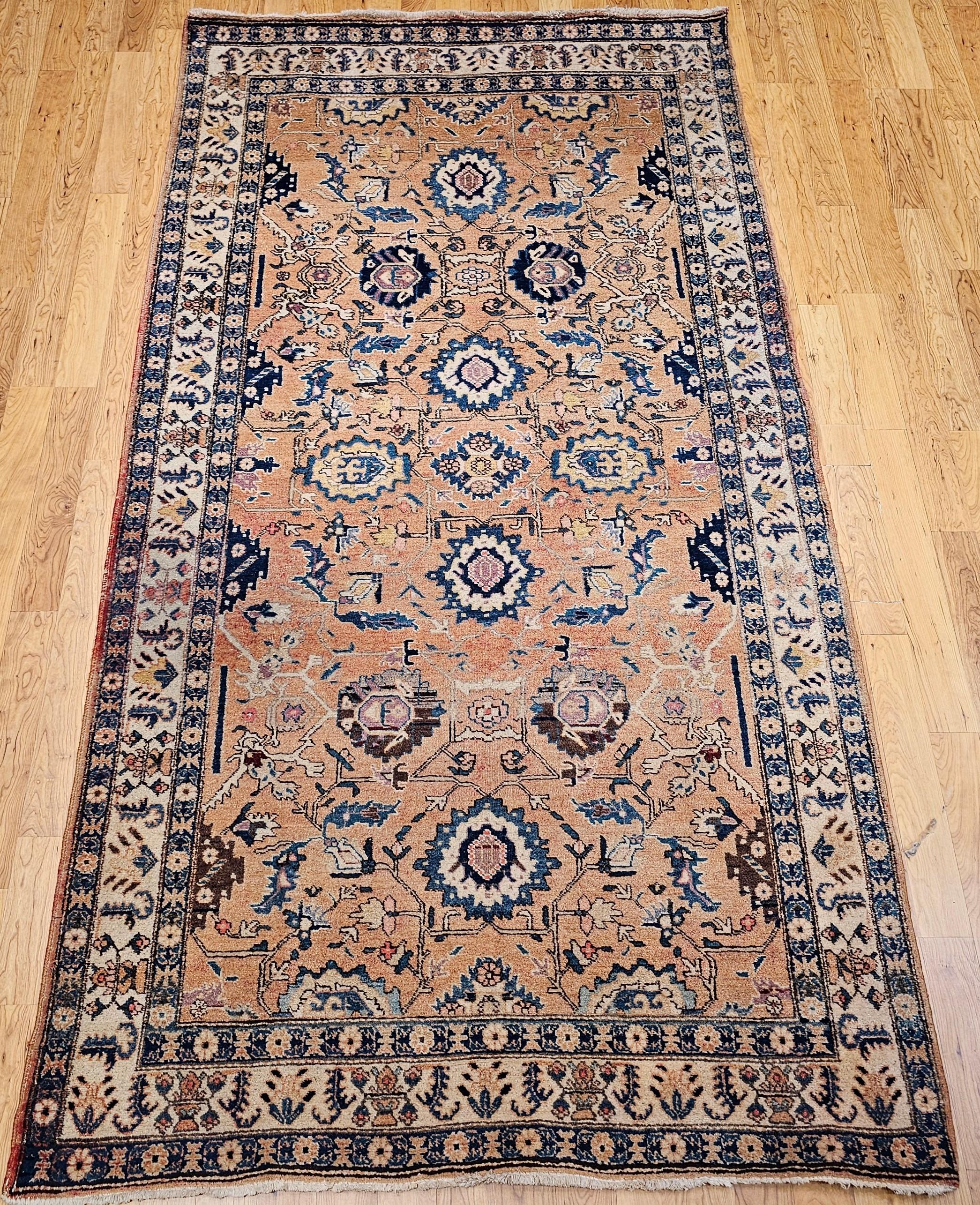 Beautiful Persian Malayer gallery or corridor size rug in an allover design from the early 1900s.  The large geometric forms are set in a tan color field.  The larger format geometric designs are navy blue, baby blue, brown, pink,  and yellow.  The