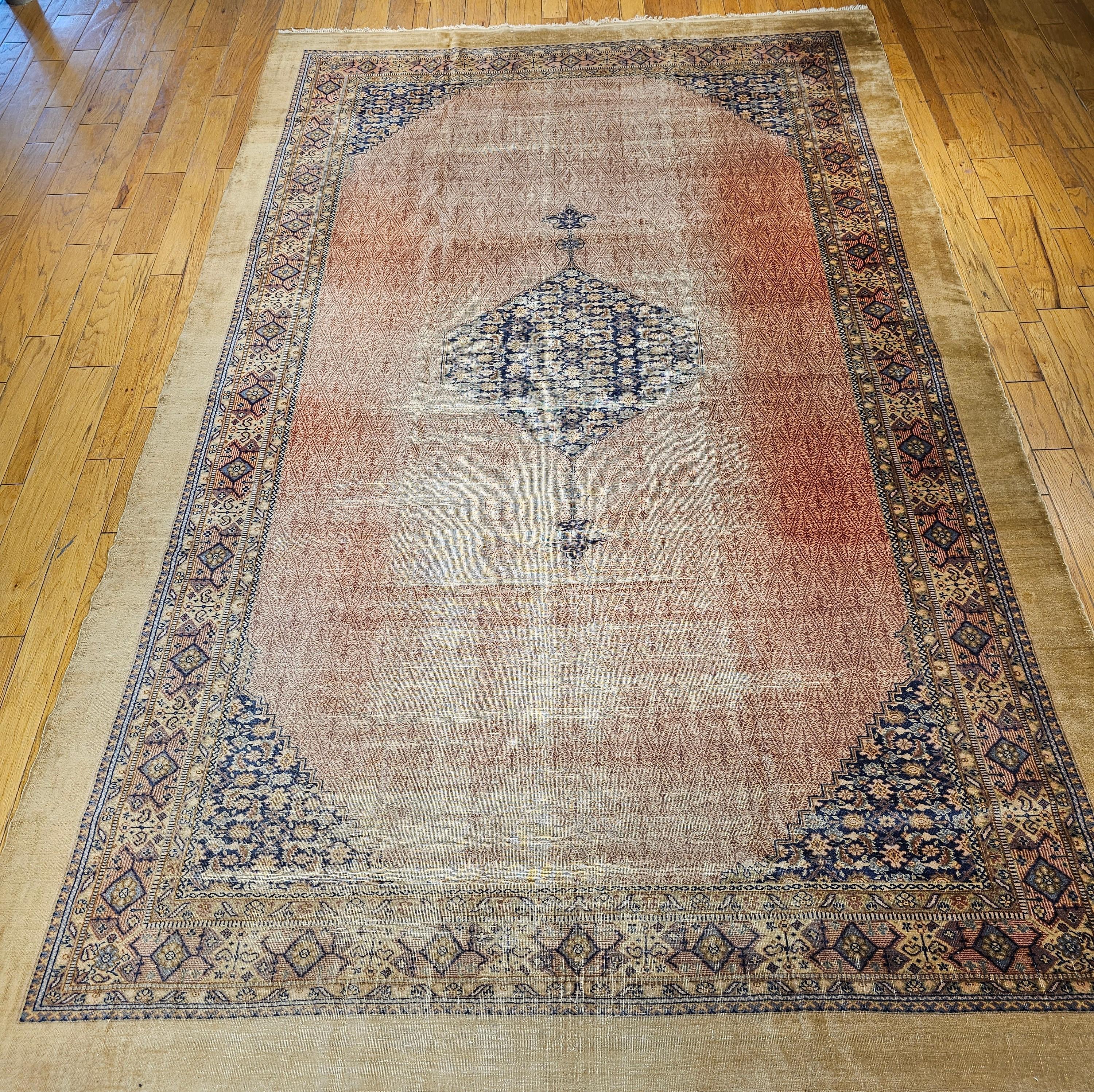 Beautiful oversize or gallery size camelhair Persian Malayer from the early 1900s.  The rug has an open field design with a central medallion in a Herati design set in a navy blue color background.  The corner spandrels are also in Herati design set