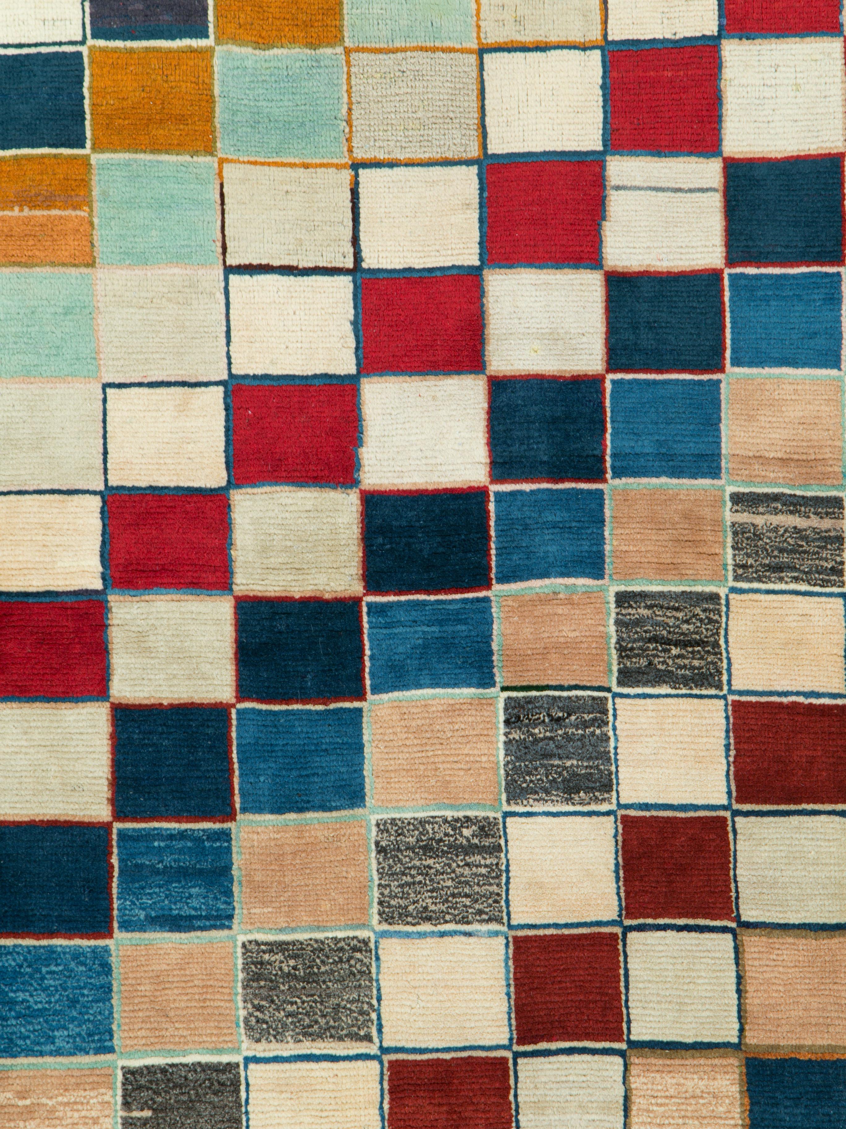 A vintage Persian Gabbeh rug from the mid-20th century with a checkerboard design utilizing a wide color palette.