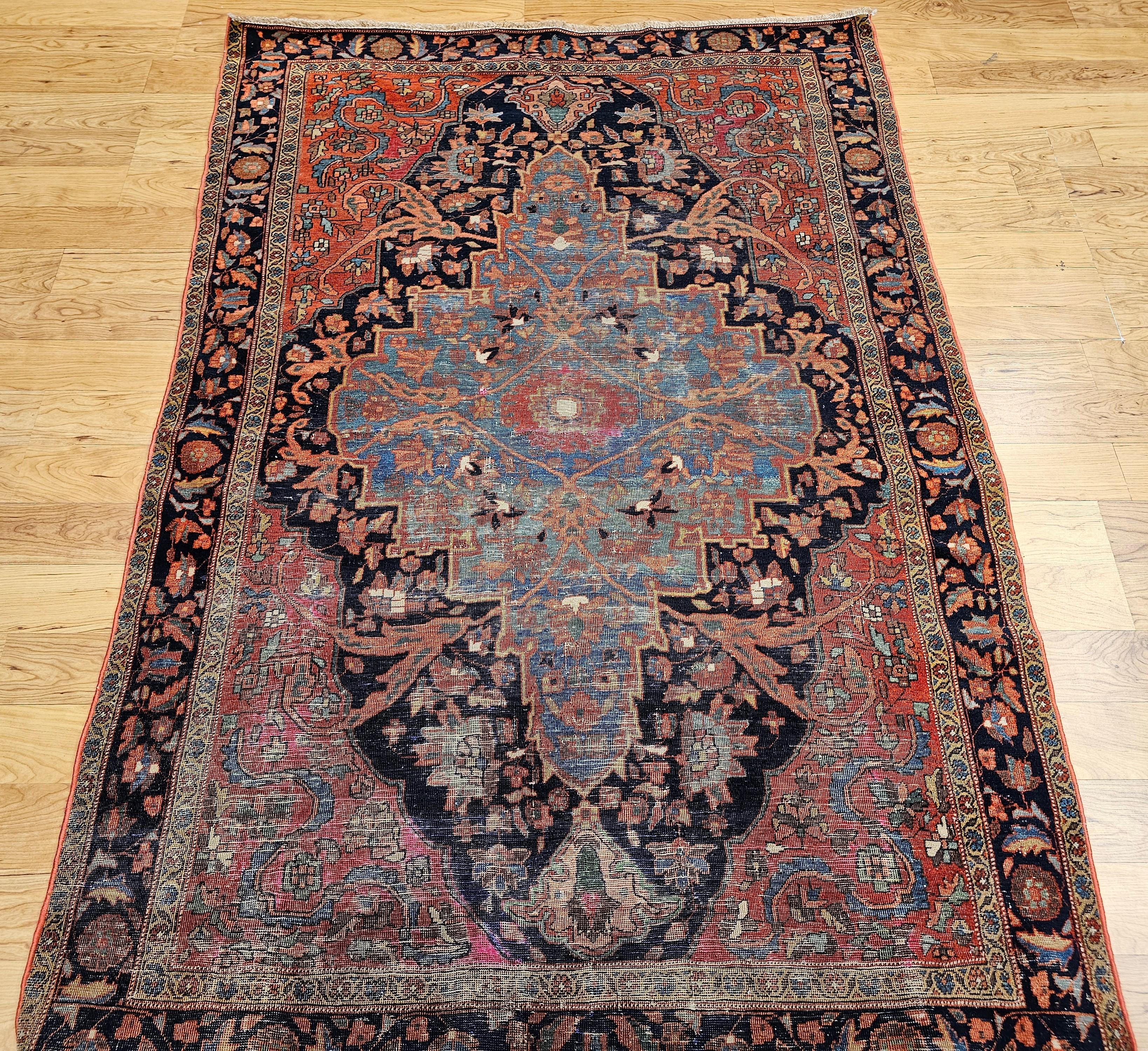 Vintage Persian Farahan with a Botanical Design in Abrash Pale Blue/Green, Navy Blue, and Red. One of the most beautiful Persian Farahan area rugs in our collection. Astonishingly beautiful design and color combination. The central pale-blue