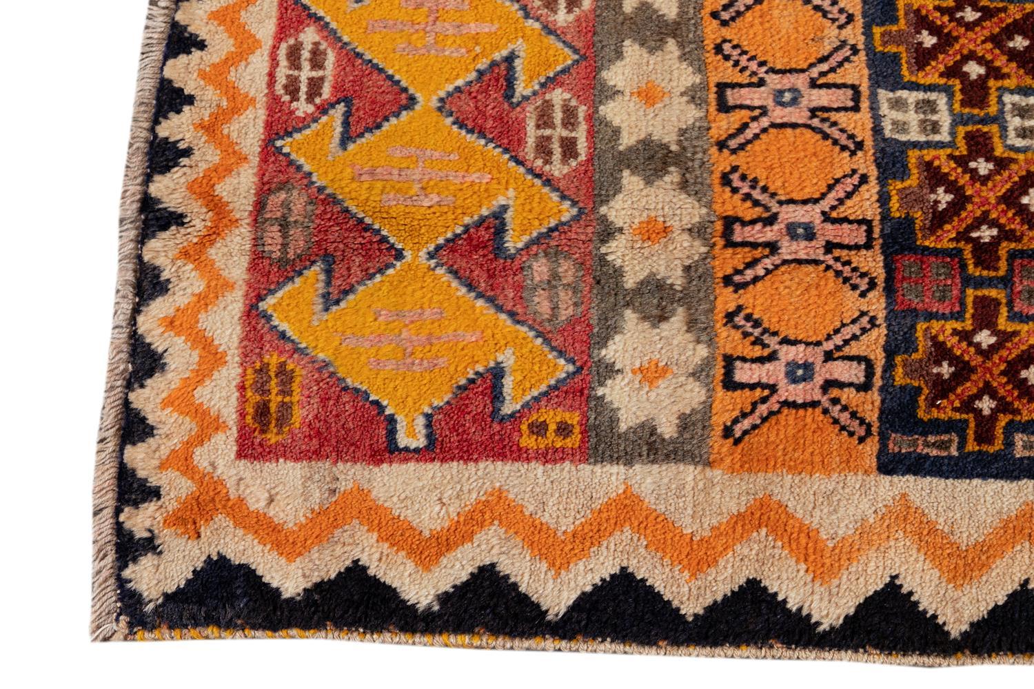 Beautiful hand knotted Persian Gabbeh rug, with an ivory and rust field, golden, black and pink accents in an all-over design.

 

This rug measures 2' 5