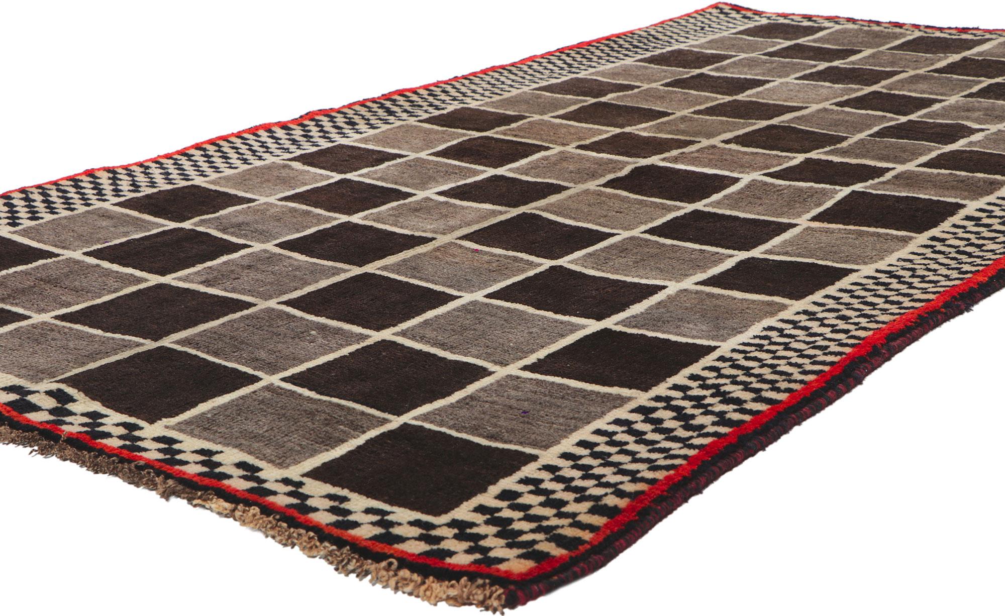 61071 Vintage Persian Gabbeh rug, 03'10 x 07'03. With its checkerboard design, incredible detail and texture, this hand knotted wool vintage Persian Gabbeh rug is a captivating vision of woven beauty. The eye-catching checkered pattern and warm