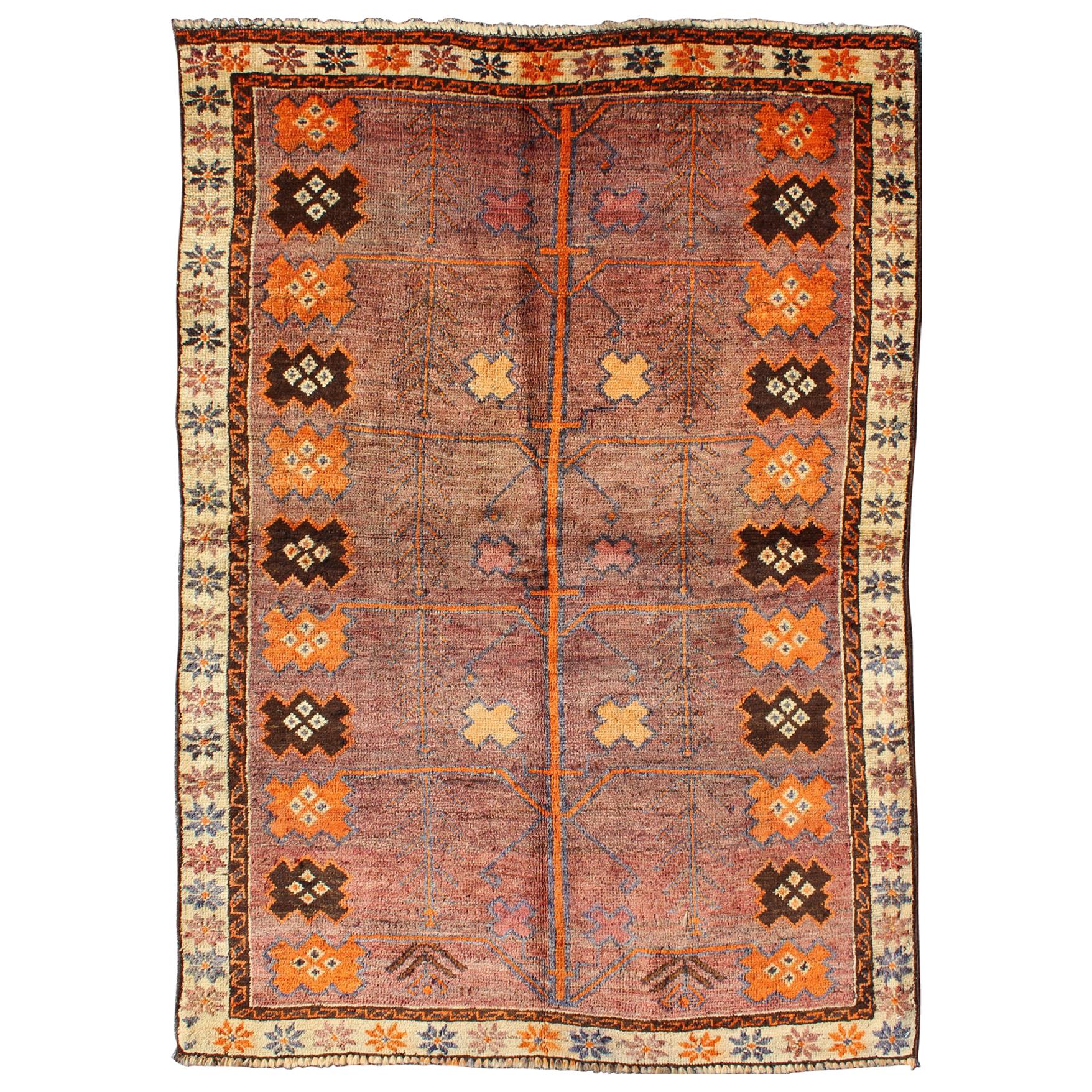 Vintage Persian Gabbeh Rug with Variegated Purple Central Field & Tribal Motifs