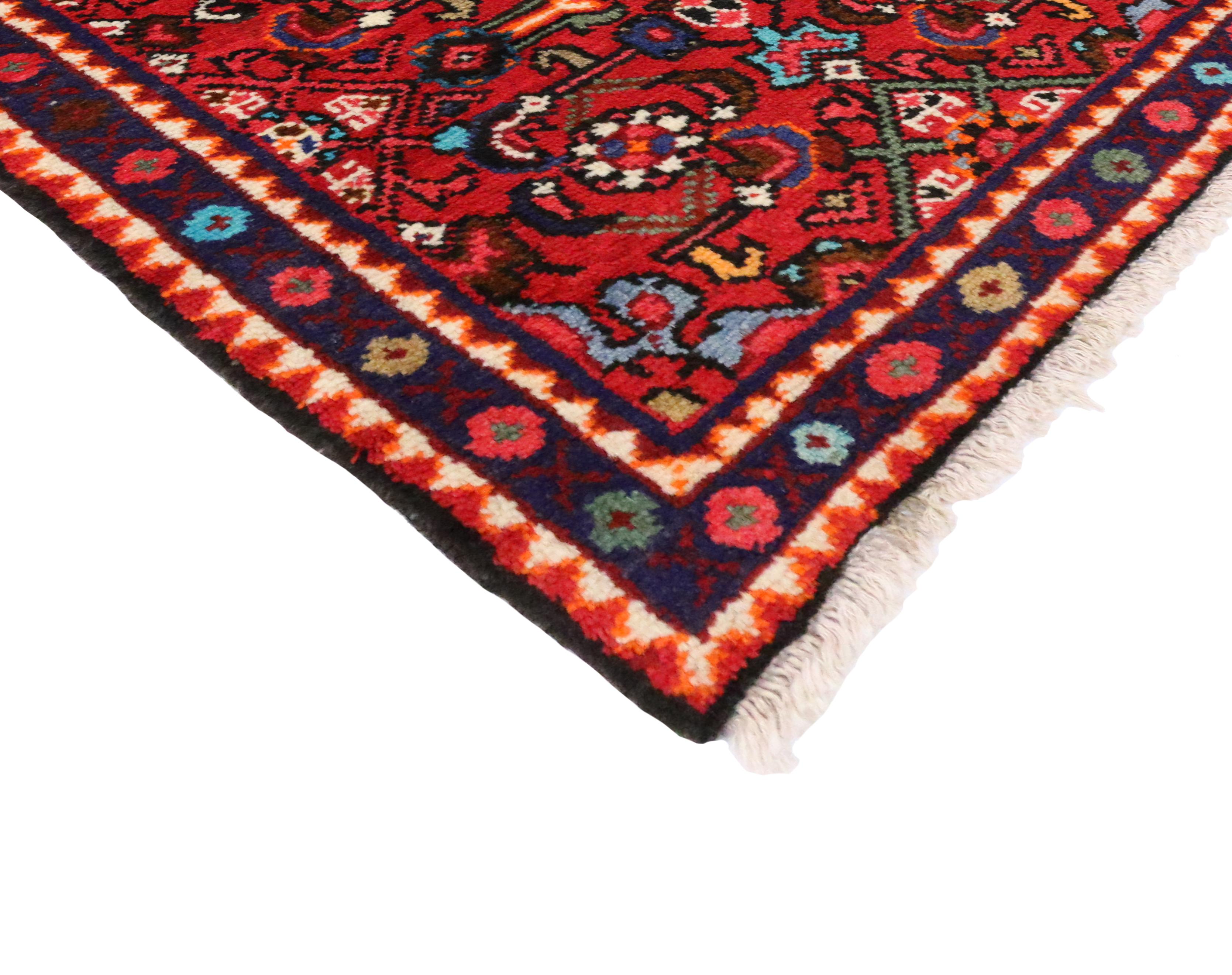 76153, vintage Persian Hamadan Accent rug, small Persian rug. This hand-knotted wool vintage Persian Hamadan accent rug features a colorful geometric design on a vibrant red field. It is enclosed by a dark blue ink border composed of alternating