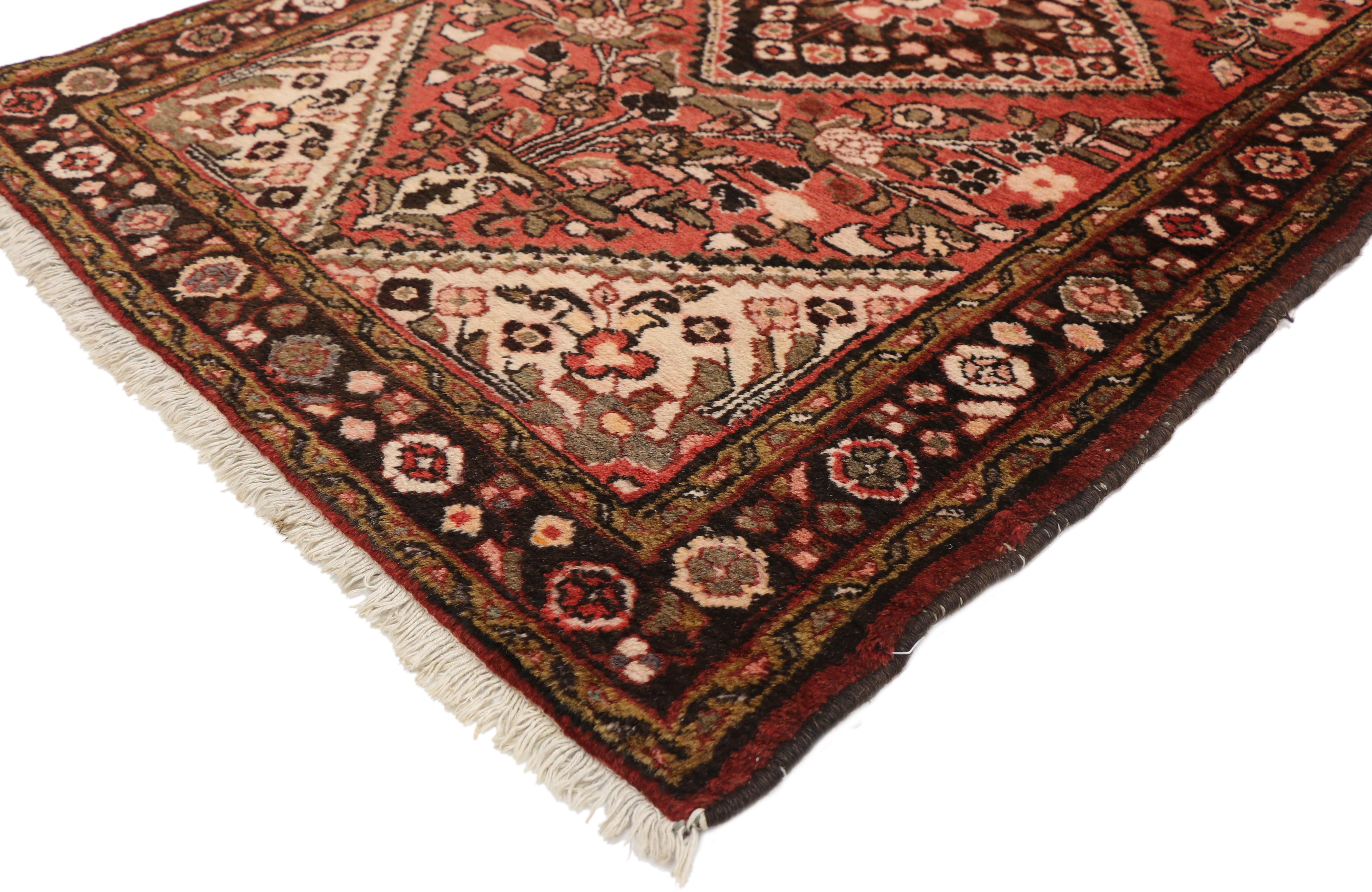 71901 vintage Persian Hamadan Accent rug with Traditional style. This hand knotted wool vintage Persian Hamadan accent rug features an onyx central medallion with zigzag edges in an abrashed red field. A Persian vase blooming with stylized flowers