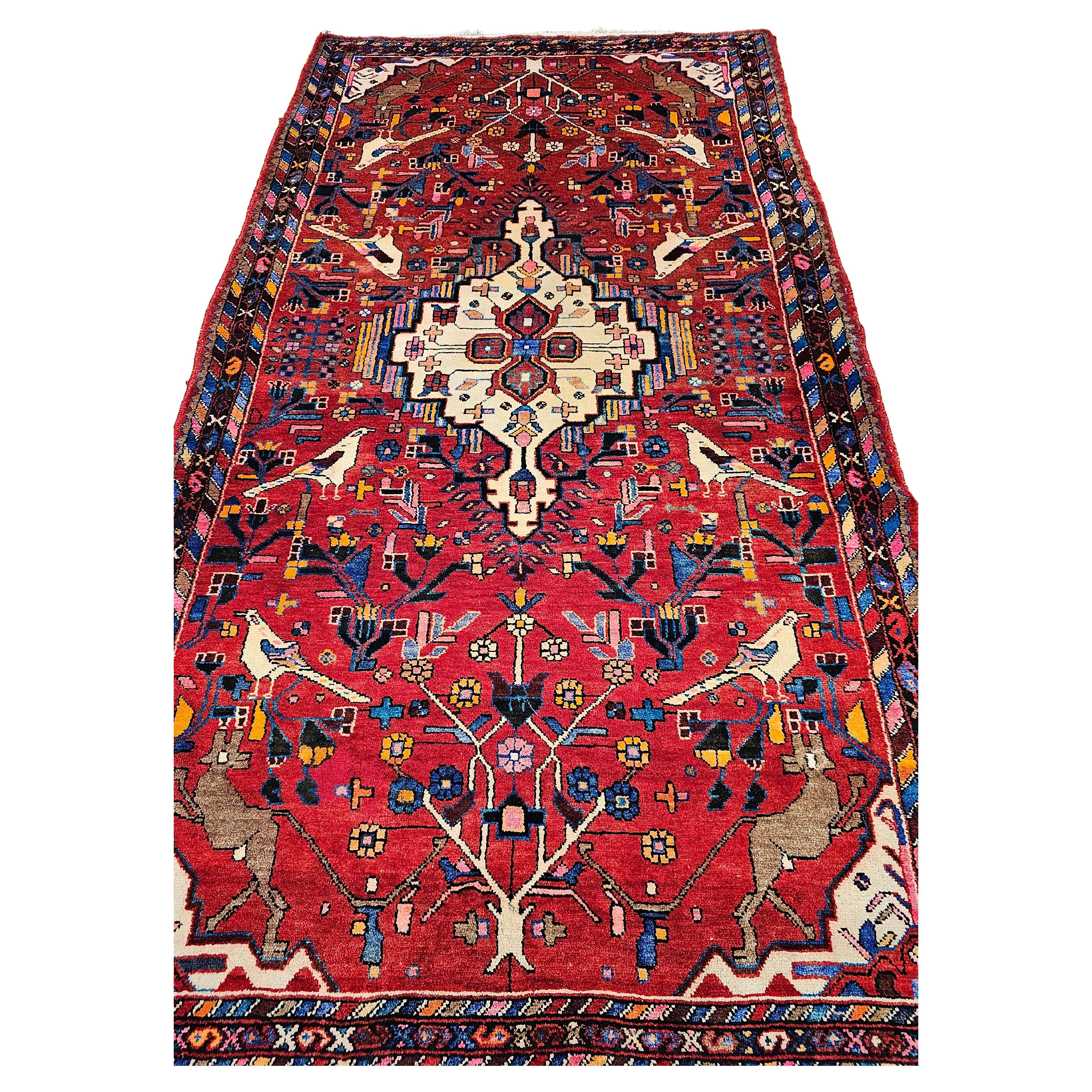 Vintage Persian Hamadan Gallery Rug with Animal Designs in Bright Red Color. There is a very unique and wonderful design of birds throughout the field. There are also designs of dogs in brown color at each end of the rug. The hand-knotted Persian