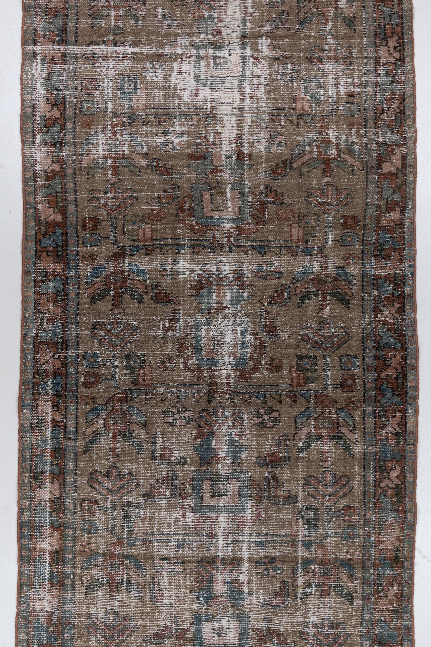Beautifully worn vintage Persian Hamadan with an earthy brown field and subtle coloration. The foundation has been repaired and this rug is safe for use in high traffic areas. 

