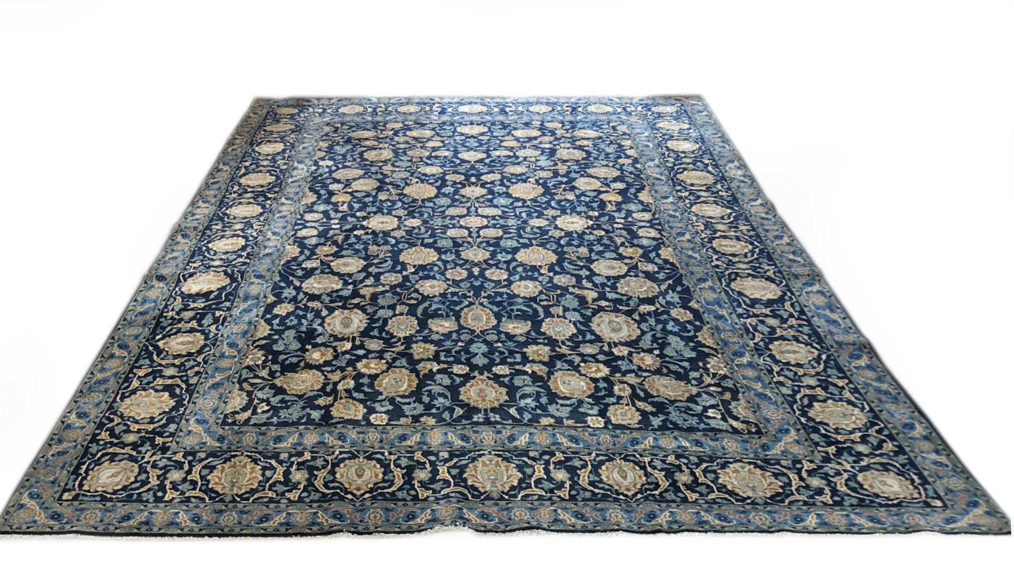 Authentic Persian Kashan with wool pile and cotton foundation. The design is all over floral, the base and border color are dark blue with the combination of light blue, cream, taupe and mustard. Kashan is located in the center of Iran in the