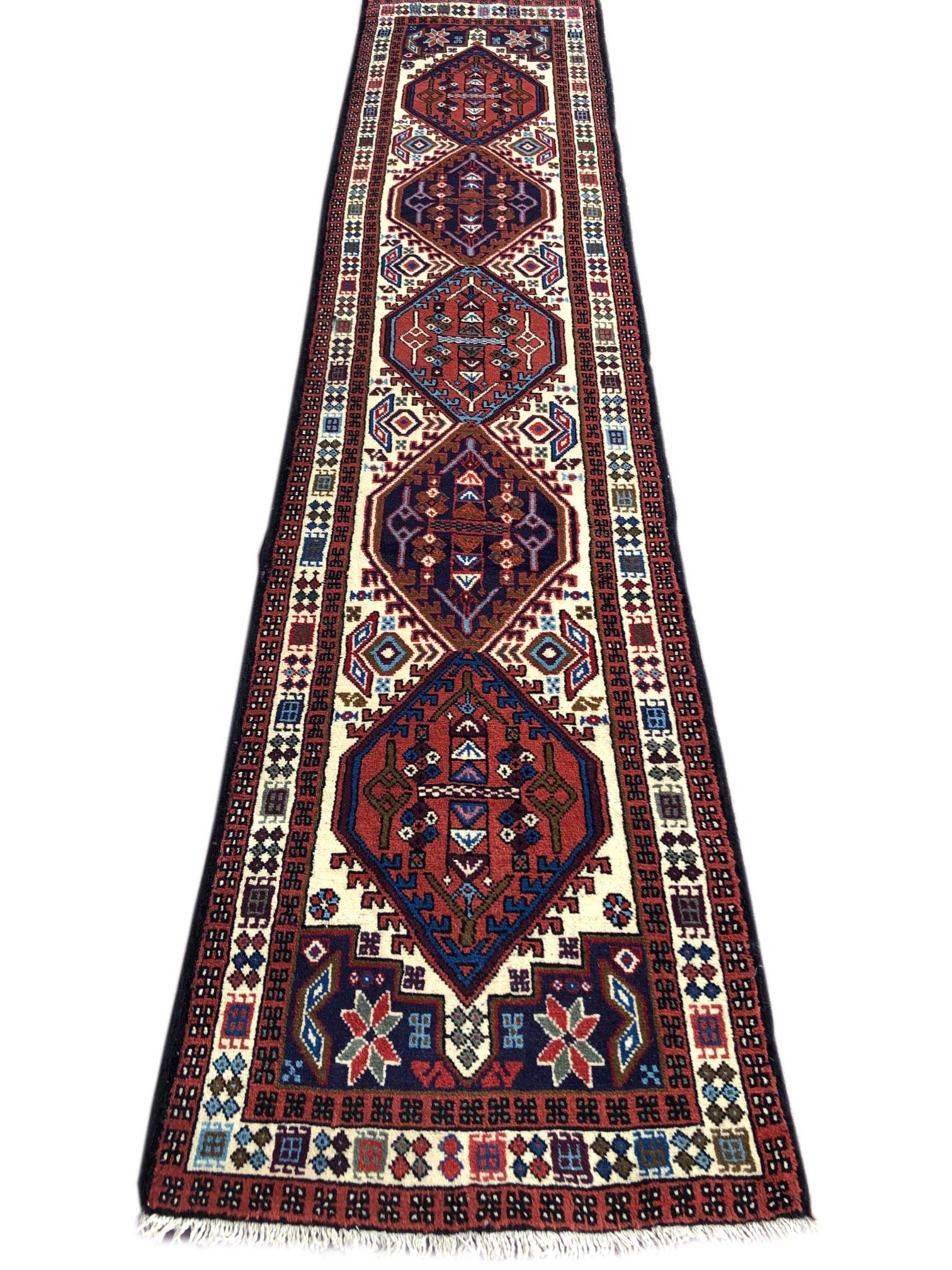 This runner is knotted in the province of Azarbayjan in north-west of Iran. The design is geometric with repeated medallion. The pile of these rugs are thick, lustrous wool, hand weaved with strong cotton as the material of choice for the