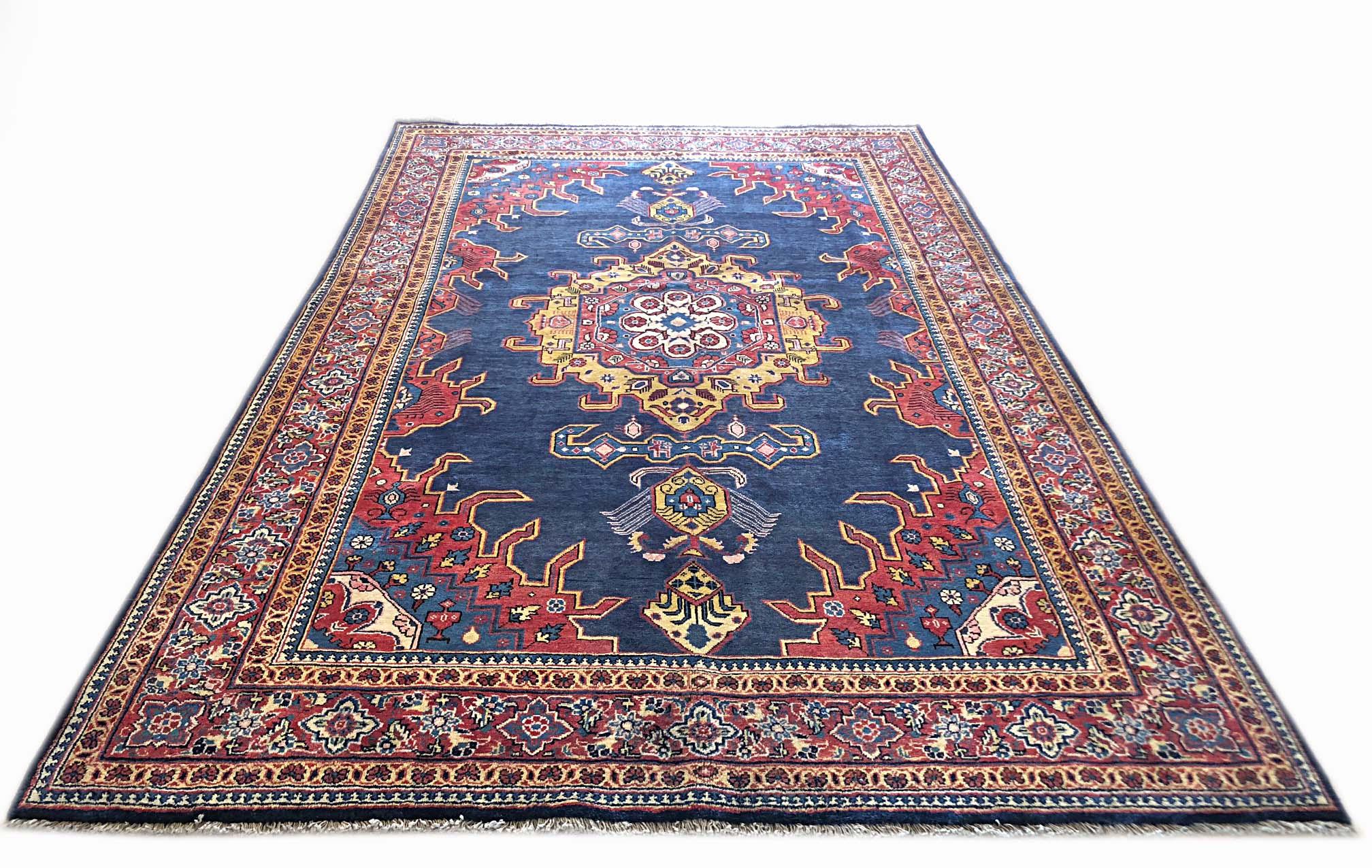 This authentic Persian Viss rug has wool pile and cotton foundation. The age of this rug is almost 50 years old. The base color is blue and the border color is rust. This beautiful piece has a hexagonal shape medallion. The size of this rug is 7